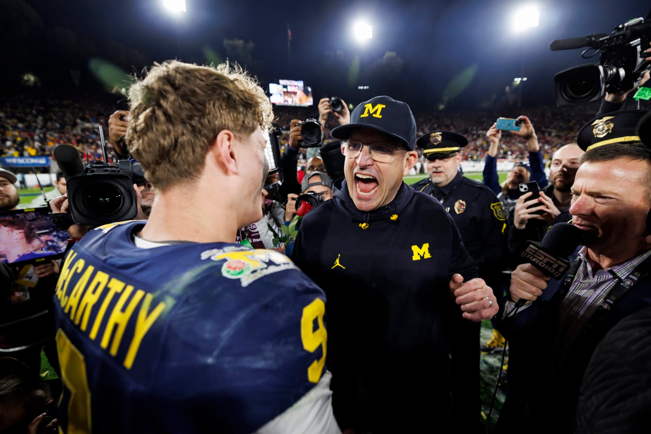 PASADENA, CALIFORNIA - JANUARY 01: Quarterback J.J. McCarthy #9 celebrates with head coach Jim Harbaugh of the Michigan Wolverines after the CFP Semifinal Rose Bowl Game against the Alabama Crimson Tide at Rose Bowl Stadium on January 1, 2024 in Pasadena, California. (Photo by Ryan Kang/Getty Images)