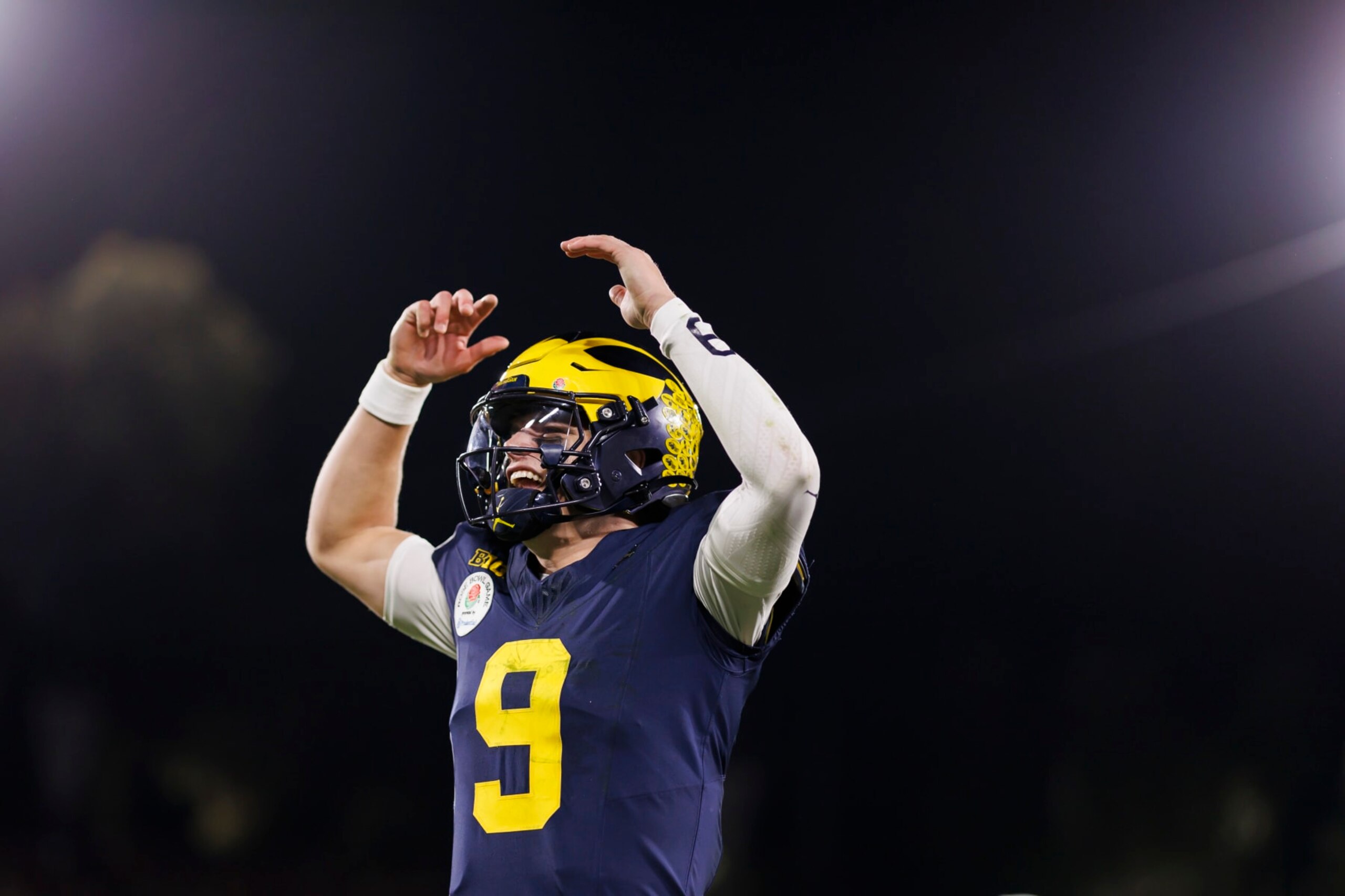 PASADENA, CALIFORNIA - JANUARY 01: Quarterback J.J. McCarthy #9 of the Michigan Wolverines celebrates on the sideline in overtime during the CFP Semifinal Rose Bowl Game against the Alabama Crimson Tide at Rose Bowl Stadium on January 1, 2024 in Pasadena, California. (Photo by Ryan Kang/Getty Images)
