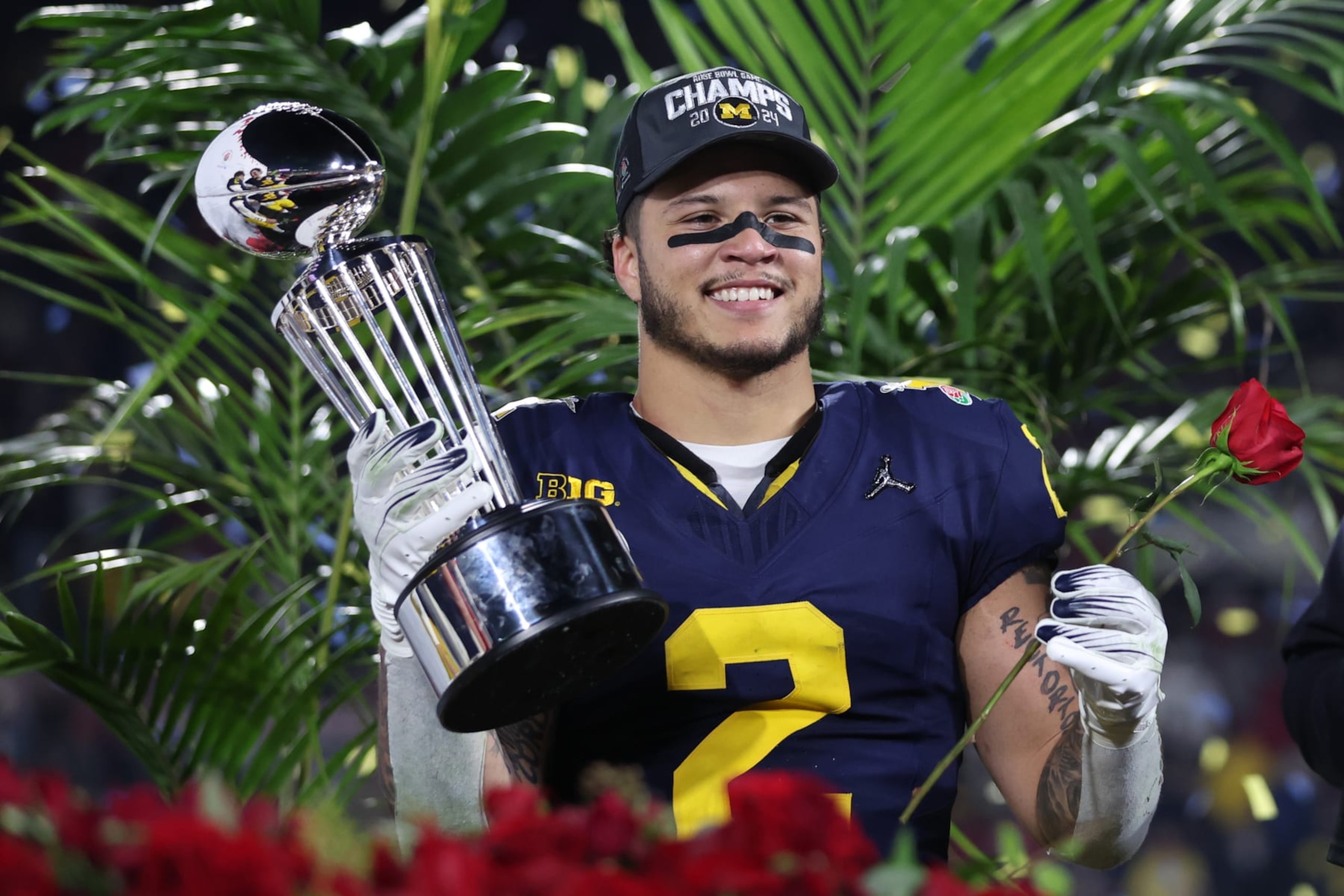 PASADENA, CALIFORNIA - JANUARY 01: Blake Corum #2 of the Michigan Wolverines celebrates with The Leishman Trophy after beating the Alabama Crimson Tide 27-20 in overtime to win the CFP Semifinal Rose Bowl Game at Rose Bowl Stadium on January 01, 2024 in Pasadena, California. (Photo by Sean M. Haffey/Getty Images)
