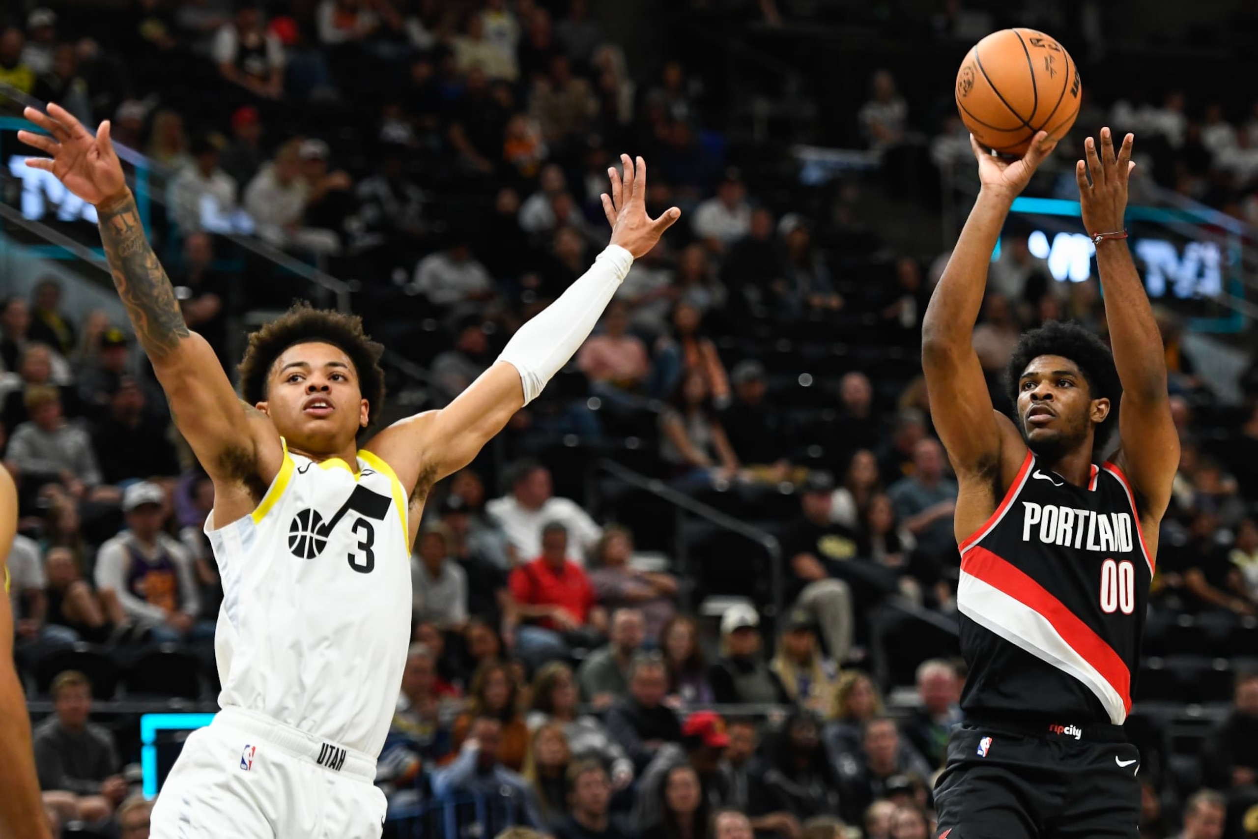 SALT LAKE CITY, UTAH - OCTOBER 14: Scoot Henderson #00 of the Portland Trail Blazers shoots over Keyonte George #3 of the Utah Jazz during the second half of a preseason NBA game at Delta Center on October 14, 2023 in Salt Lake City, Utah. NOTE TO USER: User expressly acknowledges and agrees that, by downloading and or using this photograph, User is consenting to the terms and conditions of the Getty Images License Agreement. (Photo by Alex Goodlett/Getty Images)