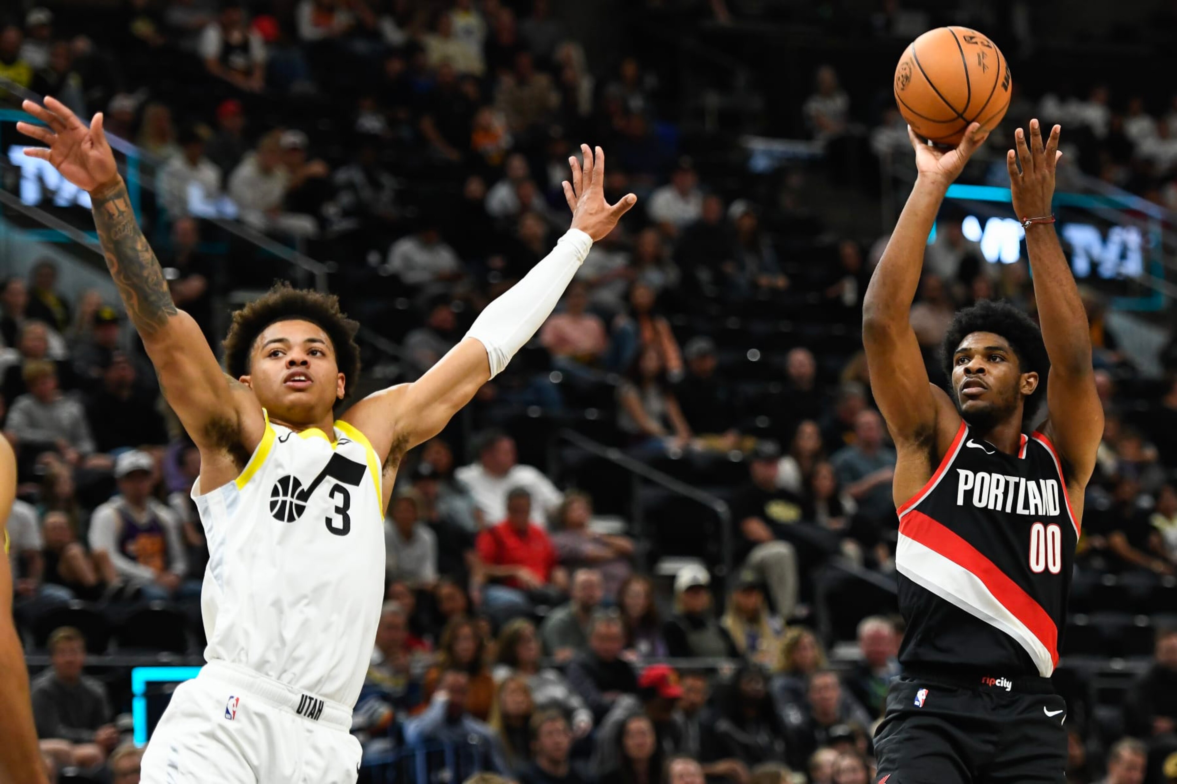 SALT LAKE CITY, UTAH - OCTOBER 14: Scoot Henderson #00 of the Portland Trail Blazers shoots over Keyonte George #3 of the Utah Jazz during the second half of a preseason NBA game at Delta Center on October 14, 2023 in Salt Lake City, Utah. NOTE TO USER: User expressly acknowledges and agrees that, by downloading and or using this photograph, User is consenting to the terms and conditions of the Getty Images License Agreement. (Photo by Alex Goodlett/Getty Images)