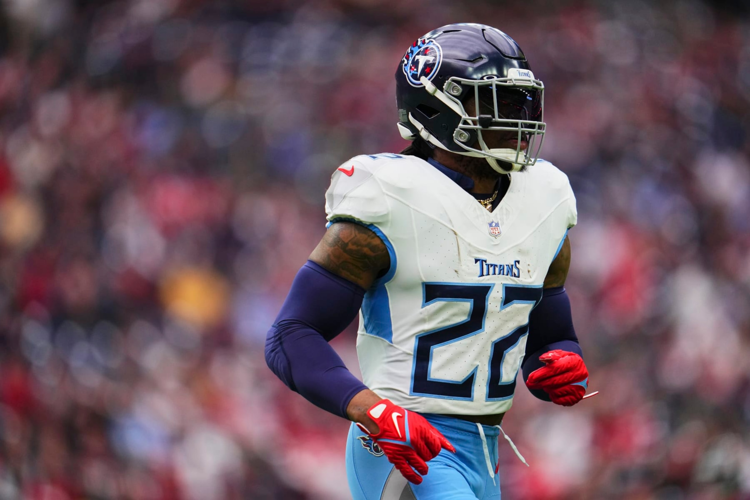 HOUSTON, TX - DECEMBER 31: Derrick Henry #22 of the Tennessee Titans jogs onto the field against the Houston Texans during the first half at NRG Stadium on December 31, 2023 in Houston, Texas. (Photo by Cooper Neill/Getty Images)