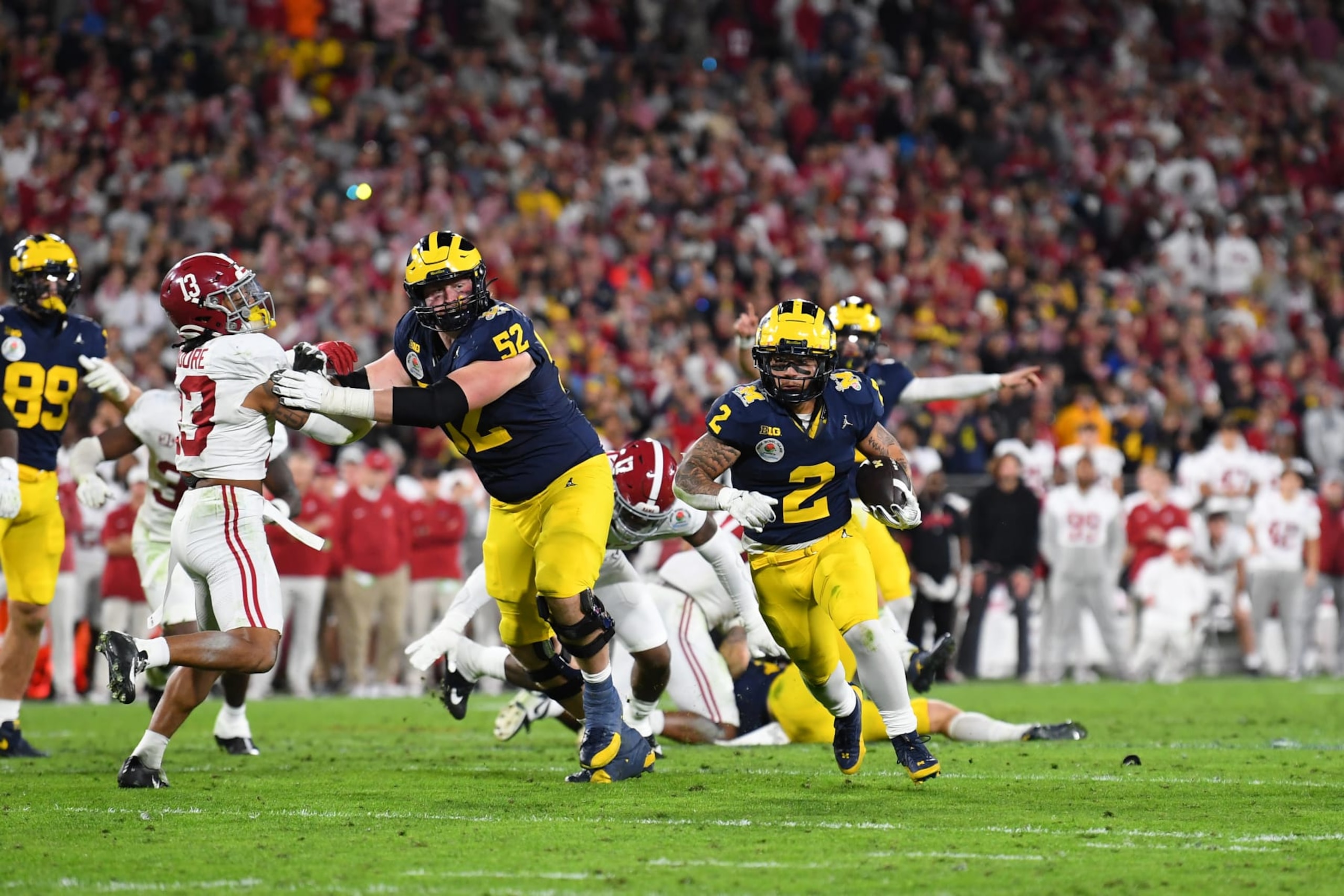 PASADENA, CA - JANUARY 01: RB Blake Corum (2) of the Michigan Wolverines scores a touchdown in overtime of the Alabama Crimson Tide game versus the Michigan Wolverines CFP Semifinal at the Rose Bowl Game on January, 1, 2024, at the Rose Bowl Stadium in Pasadena, CA. (Photo by Brian Rothmuller/Icon Sportswire via Getty Images) PASADENA, CA - JANUARY 01: RB Blake Corum (2) of the Michigan Wolverines scores a touchdown in overtime of the Alabama Crimson Tide game versus the Michigan Wolverines CFP Semifinal at the Rose Bowl Game on January, 1, 2024, at the Rose Bowl Stadium in Pasadena, CA. (Photo by Brian Rothmuller/Icon Sportswire via Getty Images)