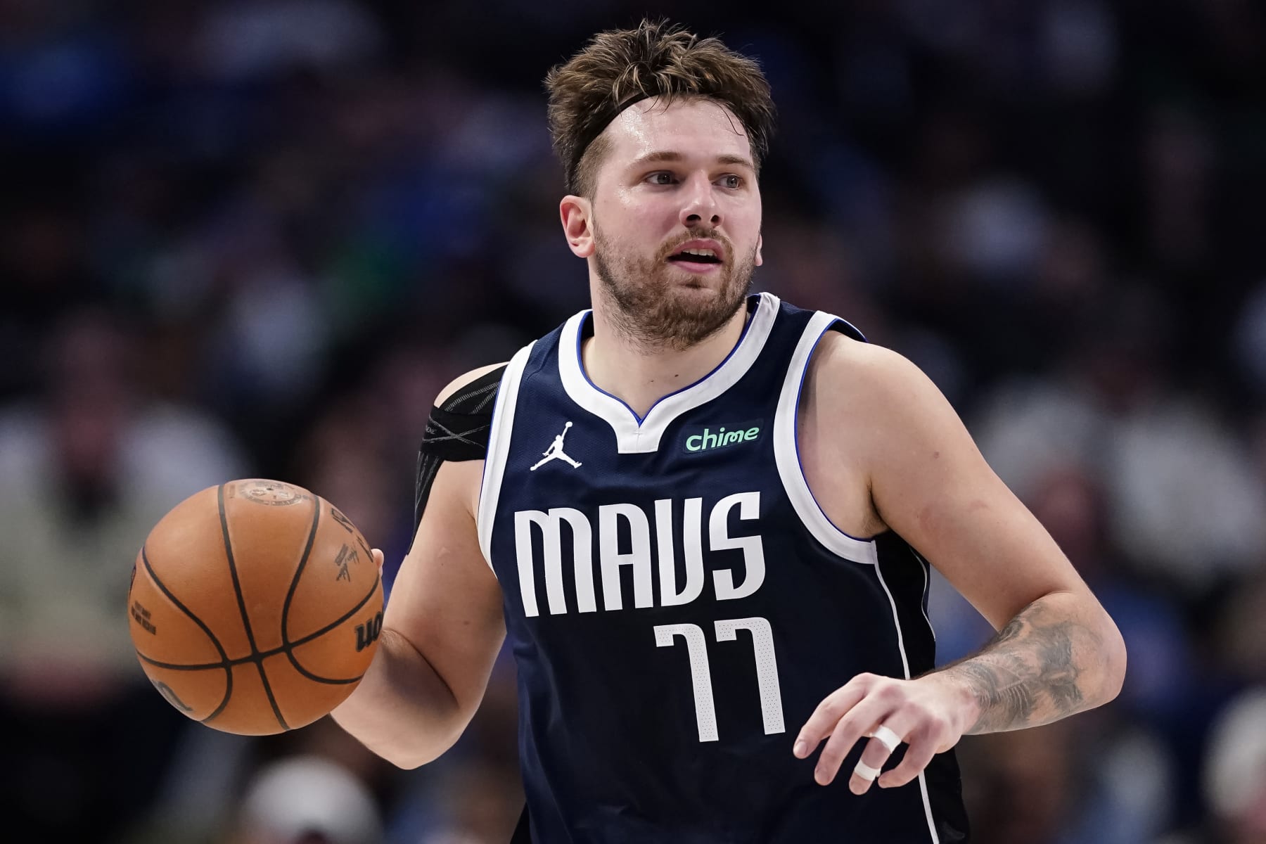DALLAS, TEXAS - JANUARY 03: Luka Doncic #77 of the Dallas Mavericks brings the ball up court during the second half against the Portland Trail Blazers at American Airlines Center on January 03, 2024 in Dallas, Texas. NOTE TO USER: User expressly acknowledges and agrees that, by downloading and or using this photograph, User is consenting to the terms and conditions of the Getty Images License Agreement. (Photo by Sam Hodde/Getty Images)