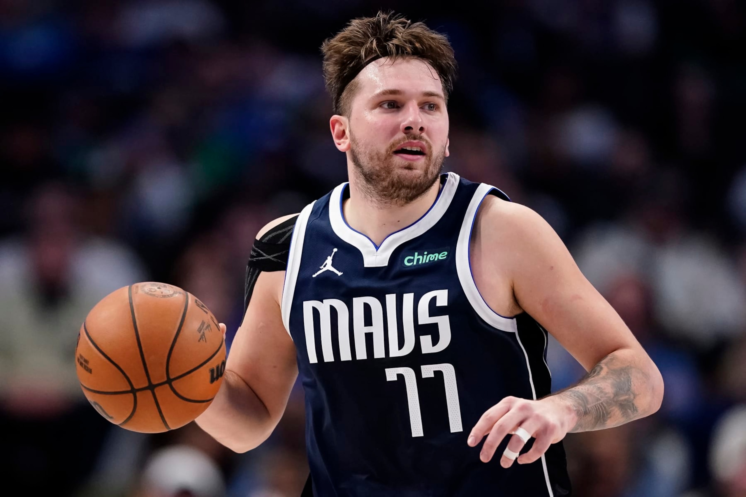 DALLAS, TEXAS - JANUARY 03: Luka Doncic #77 of the Dallas Mavericks brings the ball up court during the second half against the Portland Trail Blazers at American Airlines Center on January 03, 2024 in Dallas, Texas. NOTE TO USER: User expressly acknowledges and agrees that, by downloading and or using this photograph, User is consenting to the terms and conditions of the Getty Images License Agreement. (Photo by Sam Hodde/Getty Images)