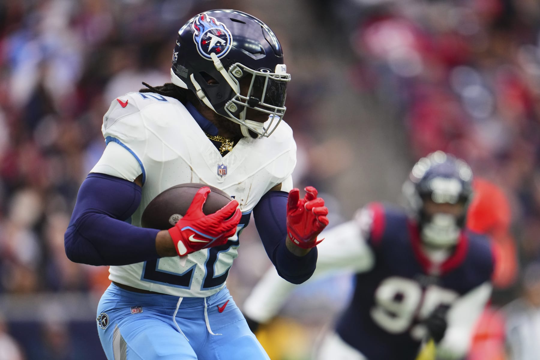 HOUSTON, TX - DECEMBER 31: Derrick Henry #22 of the Tennessee Titans carries the ball against the Houston Texans during the first half at NRG Stadium on December 31, 2023 in Houston, Texas. (Photo by Cooper Neill/Getty Images)