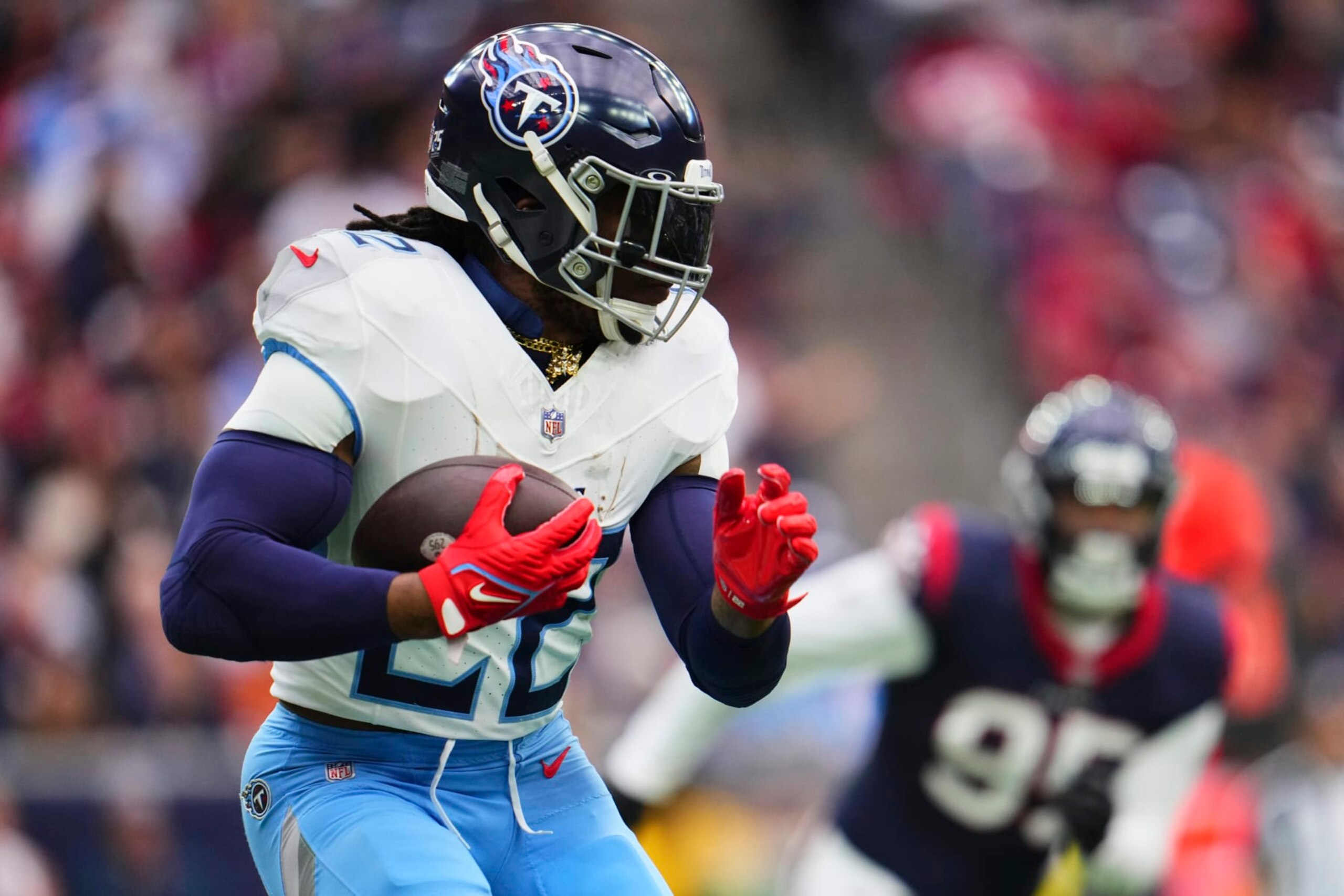 HOUSTON, TX - DECEMBER 31: Derrick Henry #22 of the Tennessee Titans carries the ball against the Houston Texans during the first half at NRG Stadium on December 31, 2023 in Houston, Texas. (Photo by Cooper Neill/Getty Images)