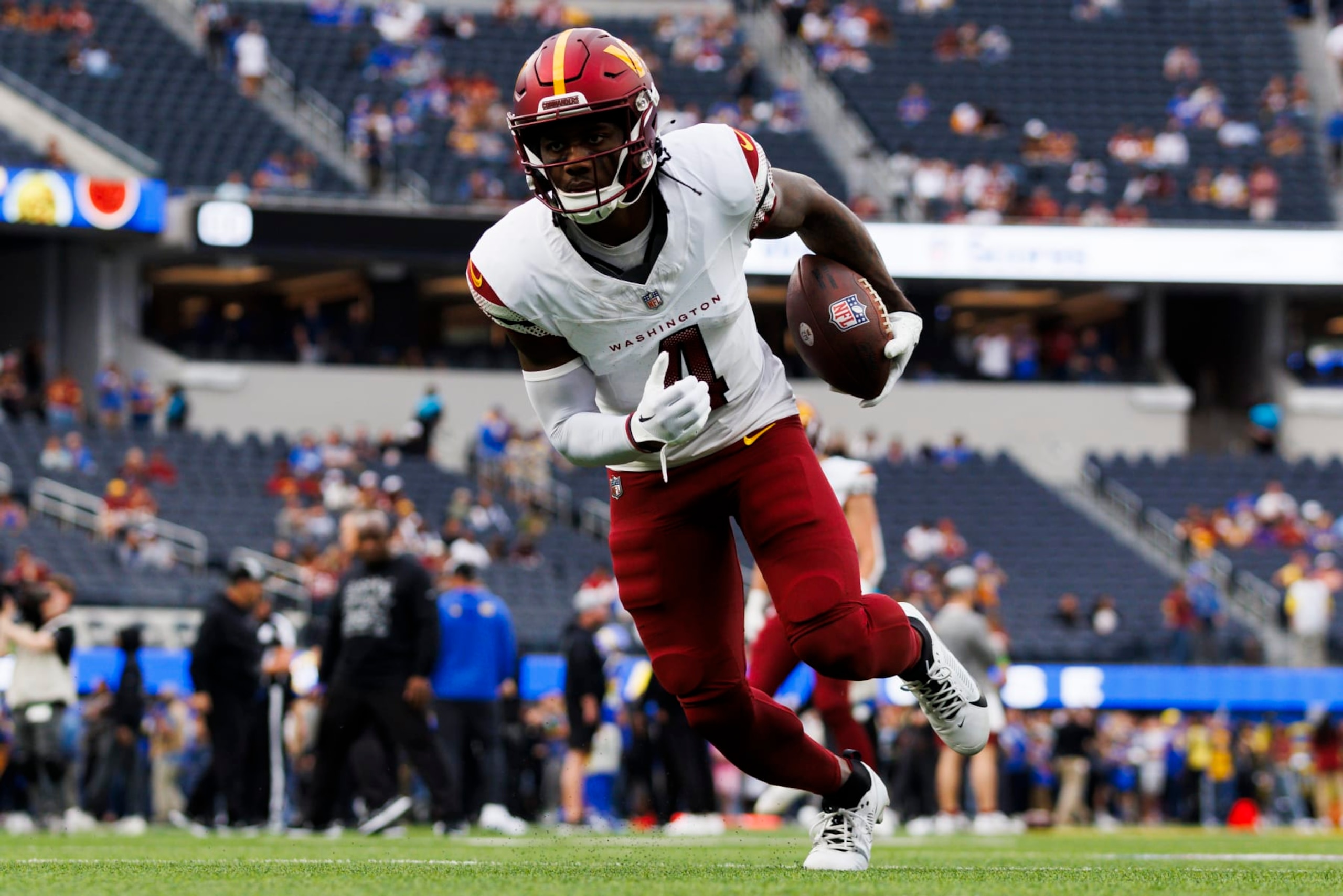 INGLEWOOD, CALIFORNIA - DECEMBER 17: Curtis Samuel #4 of the Washington Commanders runs after the catch during a game against the Los Angeles Rams at SoFi Stadium on December 17, 2023 in Inglewood, California. (Photo by Ric Tapia/Getty Images)