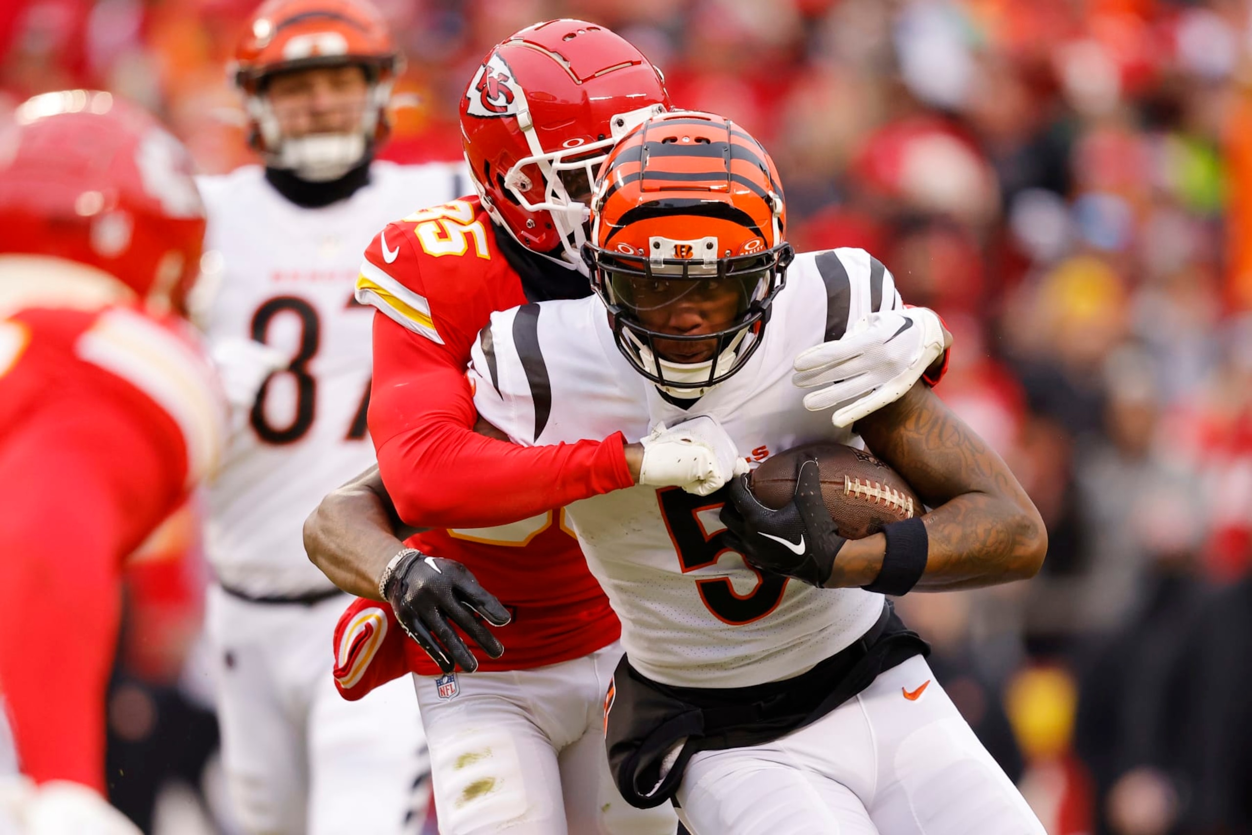 KANSAS CITY, MISSOURI - DECEMBER 31: Tee Higgins #5 of the Cincinnati Bengals is tackled by Jaylen Watson #35 of the Kansas City Chiefs during the first quarter at GEHA Field at Arrowhead Stadium on December 31, 2023 in Kansas City, Missouri. (Photo by David Eulitt/Getty Images)