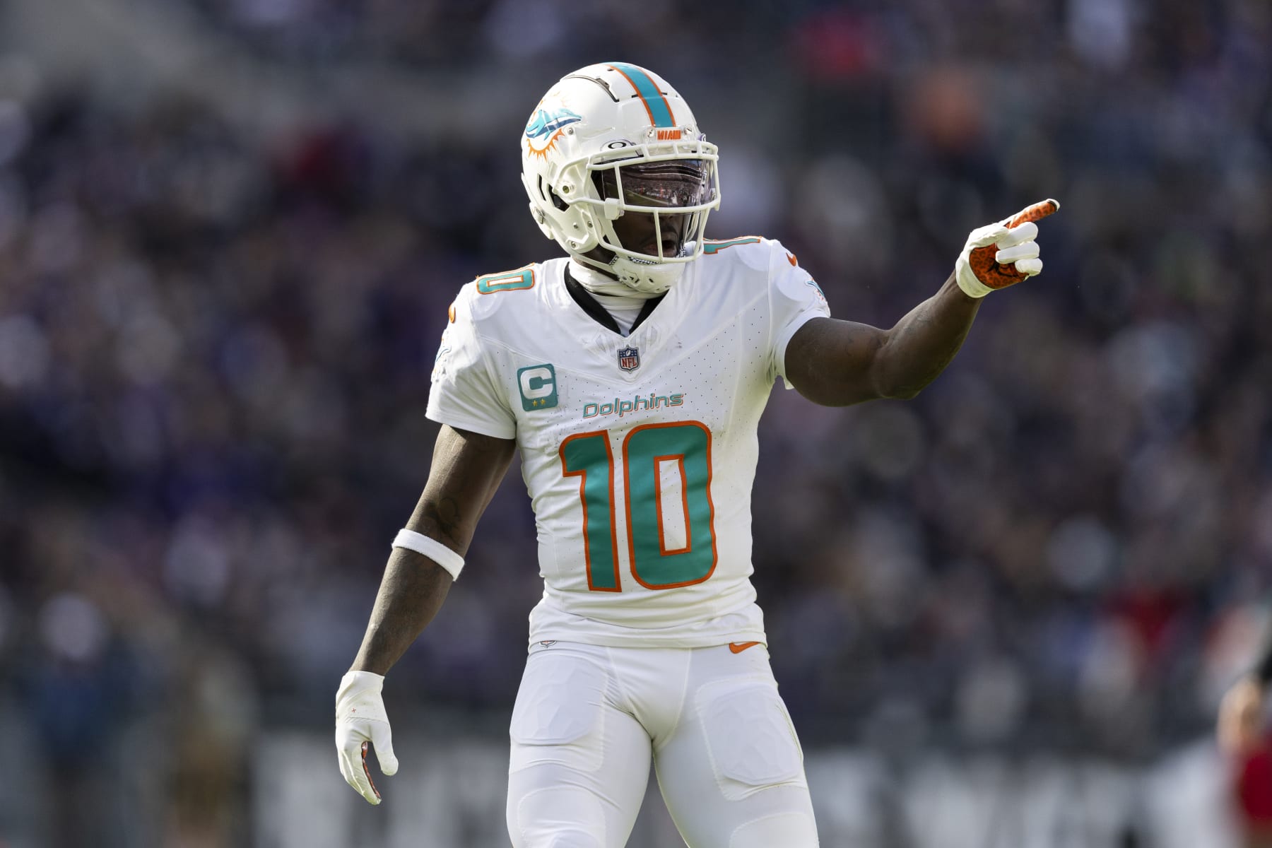 BALTIMORE, MARYLAND - DECEMBER 31: Tyreek Hill #10 of the Miami Dolphins signals as he lines up during an NFL football game between the Baltimore Ravens and the Miami Dolphins at M&T Bank Stadium on December 31, 2023 in Baltimore, Maryland. (Photo by Michael Owens/Getty Images)
