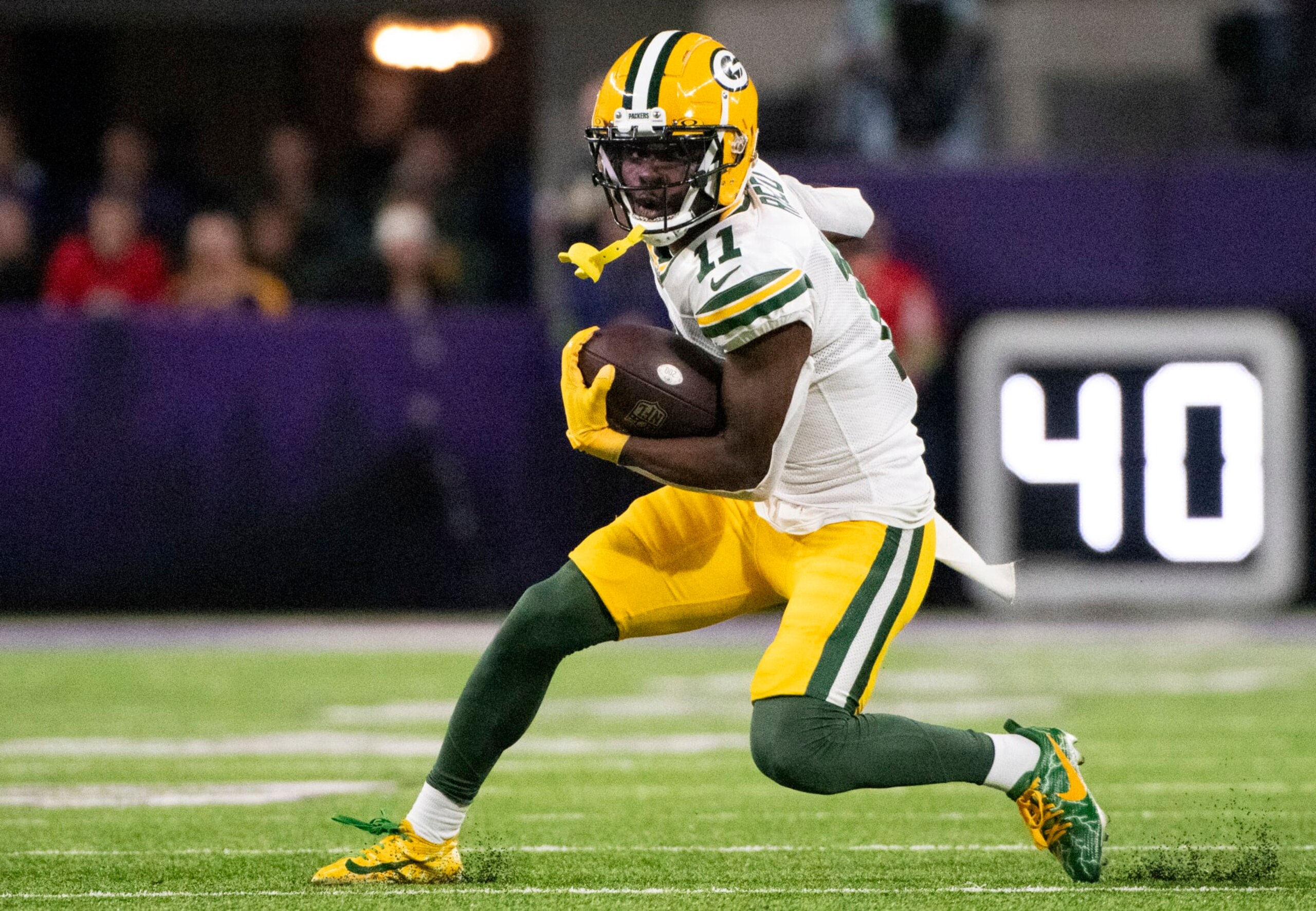 MINNEAPOLIS, MINNESOTA - DECEMBER 31: Jayden Reed #11 of the Green Bay Packers runs with the ball in the first quarter of the game against the Minnesota Vikings at U.S. Bank Stadium on December 31, 2023 in Minneapolis, Minnesota. (Photo by Stephen Maturen/Getty Images)