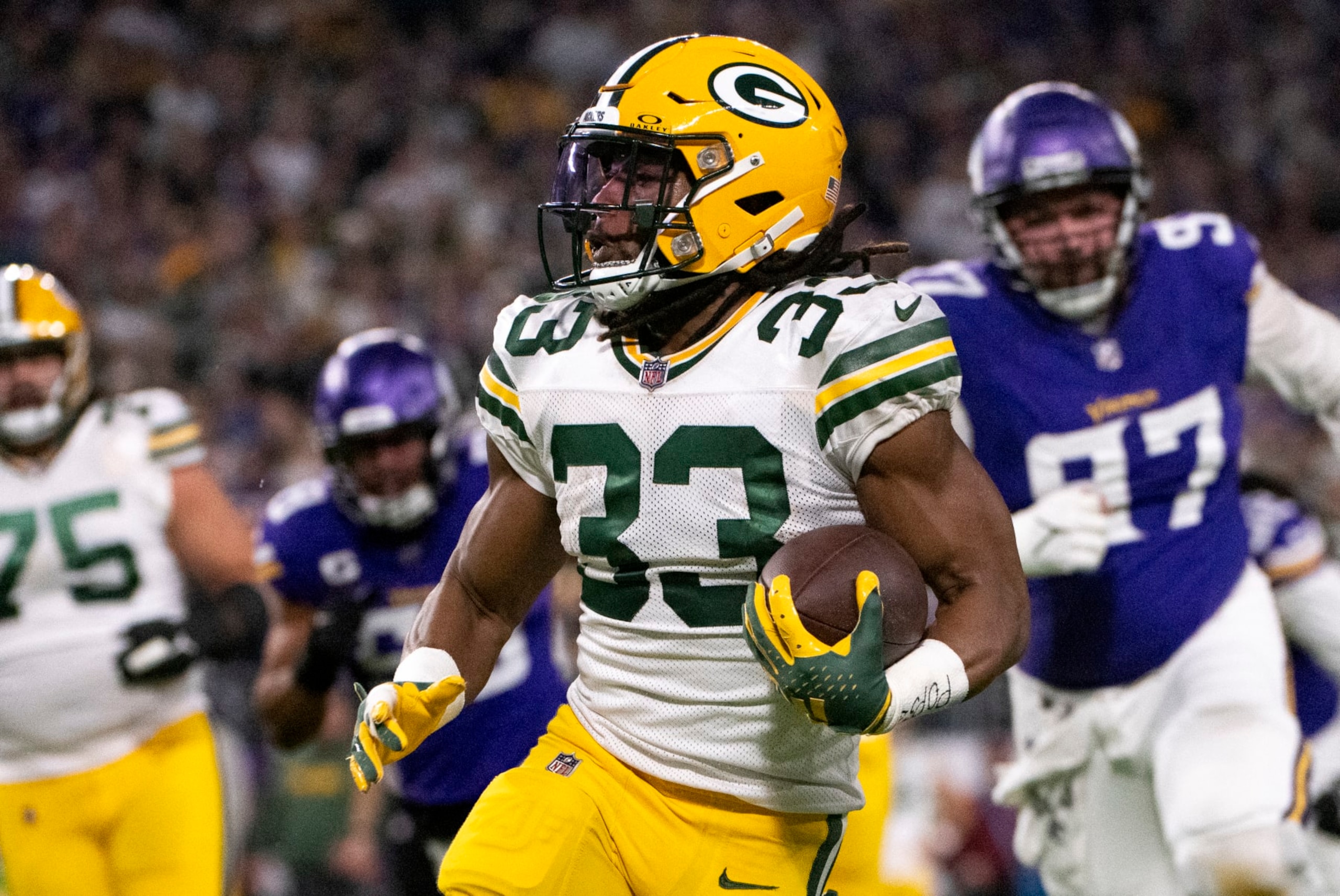MINNEAPOLIS, MINNESOTA - DECEMBER 31: Aaron Jones #33 of the Green Bay Packers carries the ball in the first quarter of the game against the Minnesota Vikings at U.S. Bank Stadium on December 31, 2023 in Minneapolis, Minnesota. (Photo by Stephen Maturen/Getty Images)