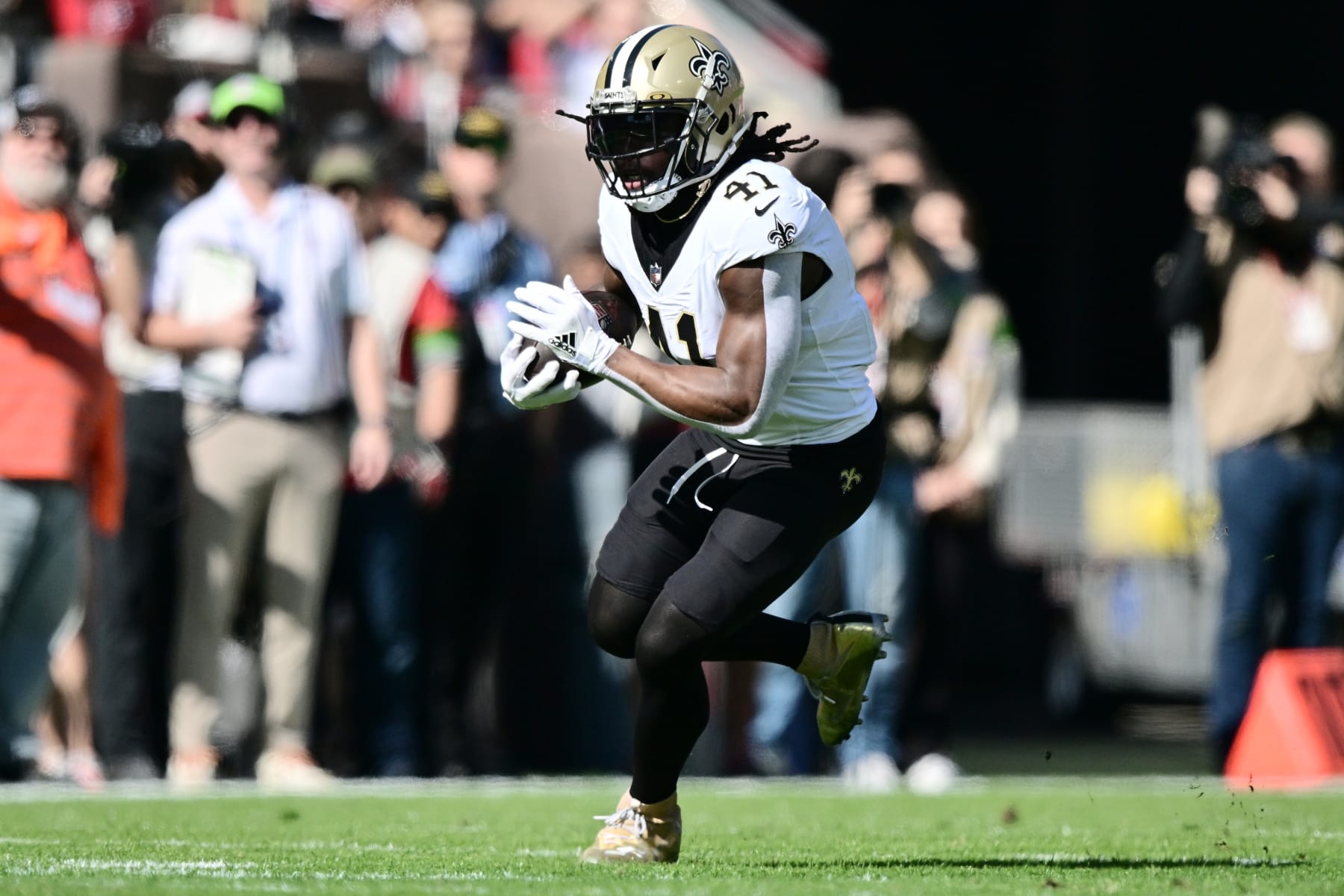 TAMPA, FLORIDA - DECEMBER 31: Alvin Kamara #41 of the New Orleans Saints runs with the ball during the first quarter against the Tampa Bay Buccaneers at Raymond James Stadium on December 31, 2023 in Tampa, Florida. (Photo by Julio Aguilar/Getty Images)