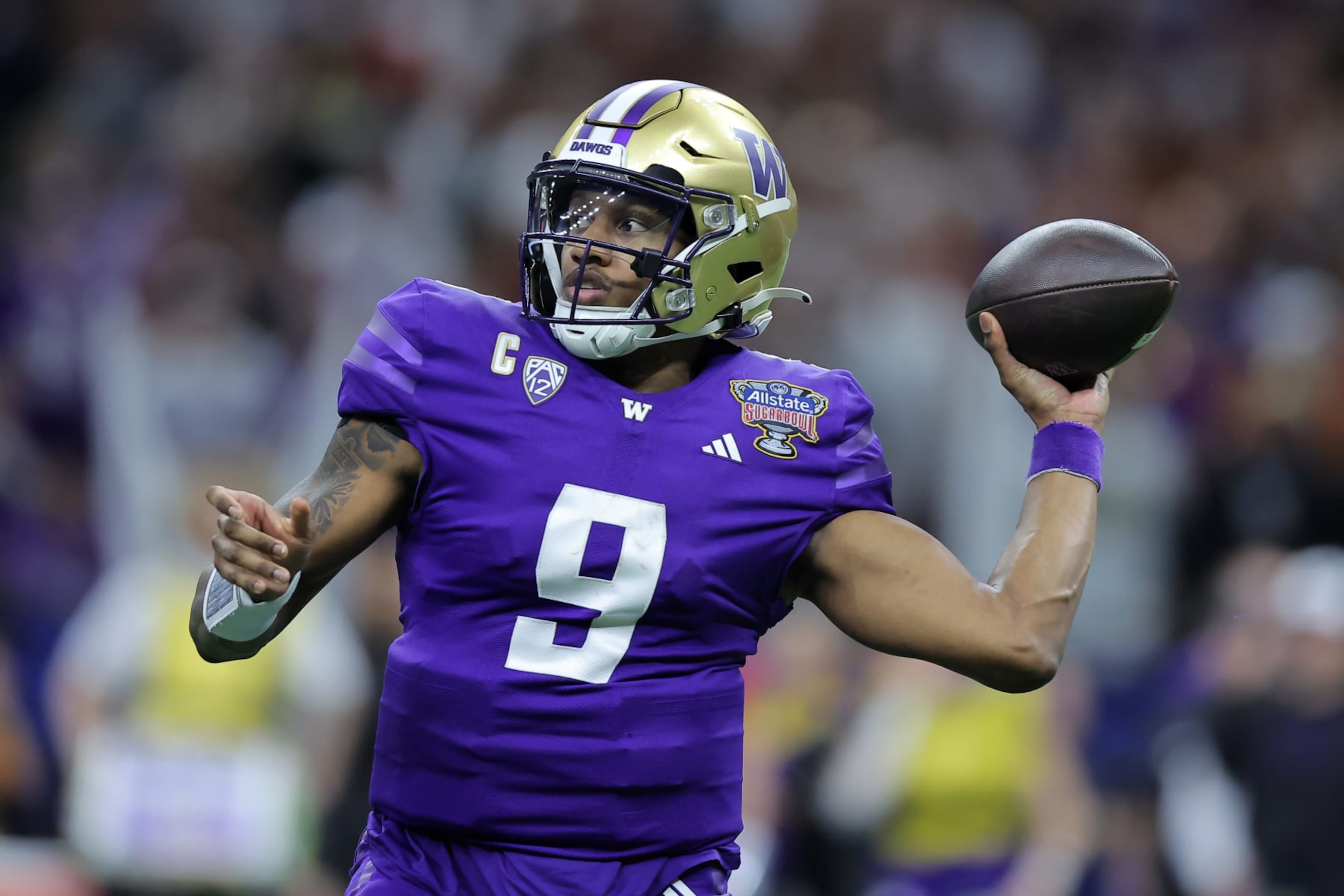 NEW ORLEANS, LOUISIANA - JANUARY 01: Michael Penix Jr. #9 of the Washington Huskies throws the ball against the Texas Longhorns during the CFP Semifinal Allstate Sugar Bowl at Caesars Superdome on January 01, 2024 in New Orleans, Louisiana. (Photo by Jonathan Bachman/Getty Images)