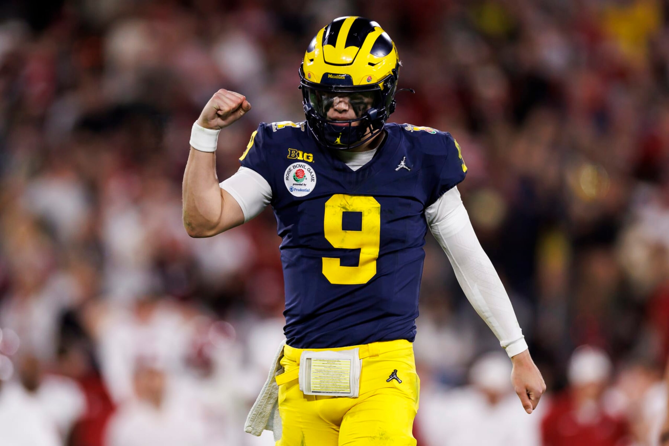 PASADENA, CALIFORNIA - JANUARY 01: Quarterback J.J. McCarthy #9 of the Michigan Wolverines celebrates after scoring a touchdown in overtime during the CFP Semifinal Rose Bowl Game against the Alabama Crimson Tide at Rose Bowl Stadium on January 1, 2024 in Pasadena, California. (Photo by Ryan Kang/Getty Images)