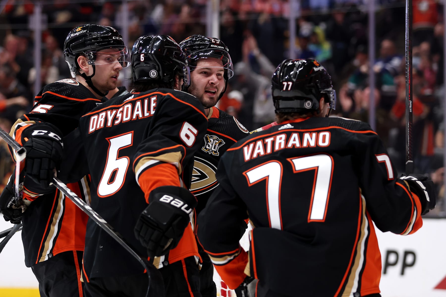 ANAHEIM, CALIFORNIA - JANUARY 03: Urho Vaakanainen #5, Jamie Drysdale #6 and Mason McTavish #23 congratulate Frank Vatrano #77 of the Anaheim Ducks after his goal during the second period of a game against the Toronto Maple Leafs at Honda Center on January 03, 2024 in Anaheim, California. (Photo by Sean M. Haffey/Getty Images)