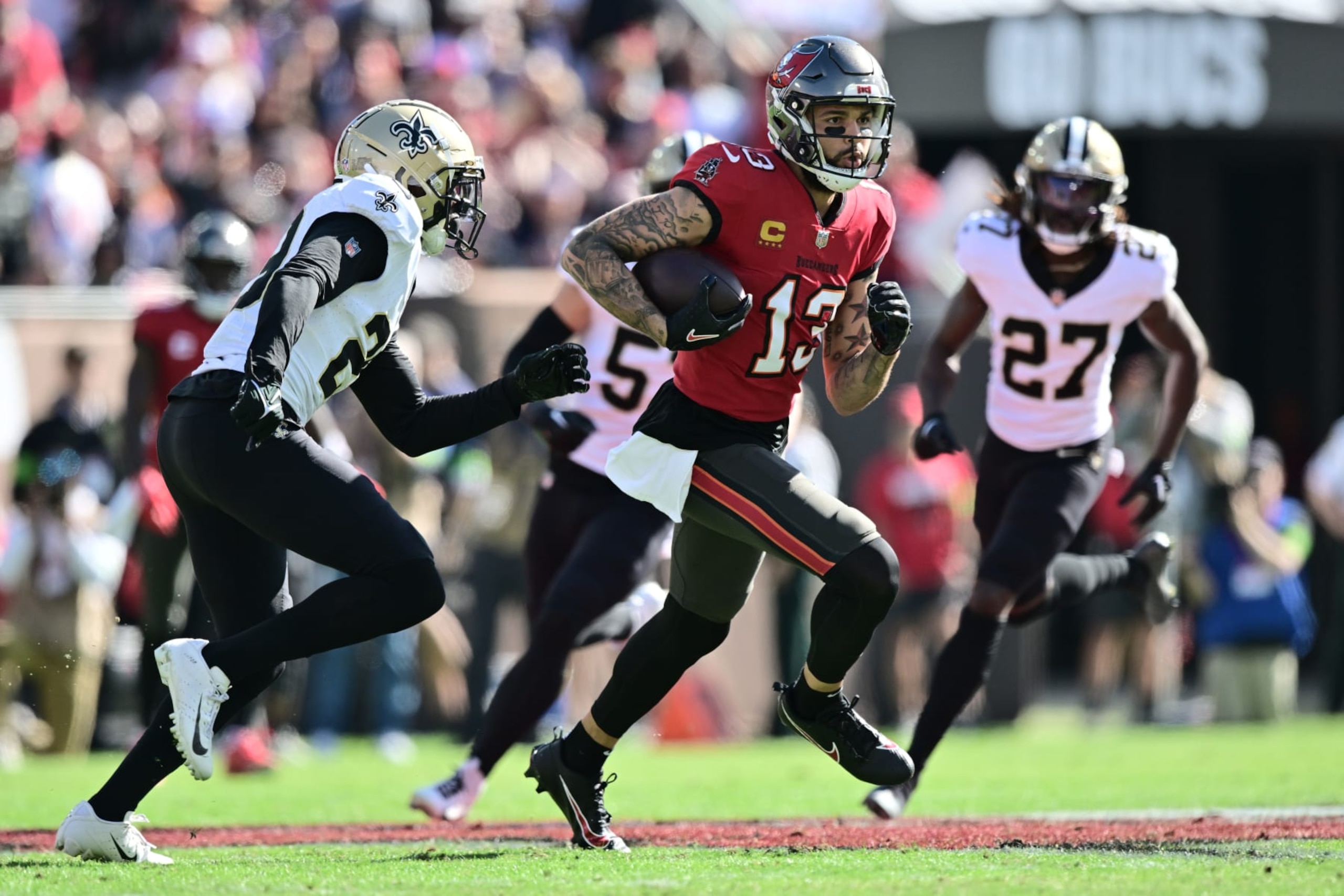 TAMPA, FLORIDA - DECEMBER 31: Mike Evans #13 of the Tampa Bay Buccaneers runs with the ball during the first quarter against the New Orleans Saints at Raymond James Stadium on December 31, 2023 in Tampa, Florida. (Photo by Julio Aguilar/Getty Images)