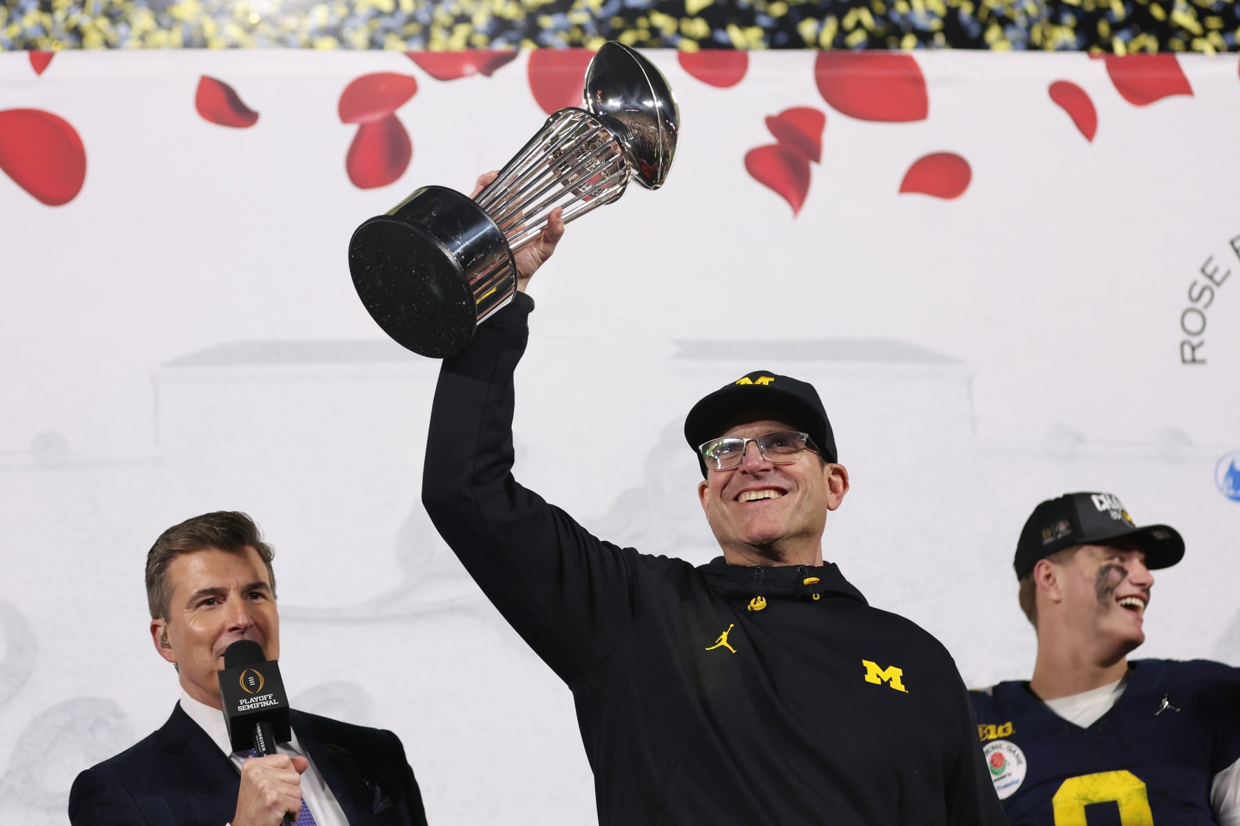 PASADENA, CALIFORNIA - JANUARY 01: Head coach Jim Harbaugh of the Michigan Wolverines celebrates with The Leishman Trophy after beating the Alabama Crimson Tide 27-20 in overtime to win the CFP Semifinal Rose Bowl Game at Rose Bowl Stadium on January 01, 2024 in Pasadena, California. (Photo by Sean M. Haffey/Getty Images)