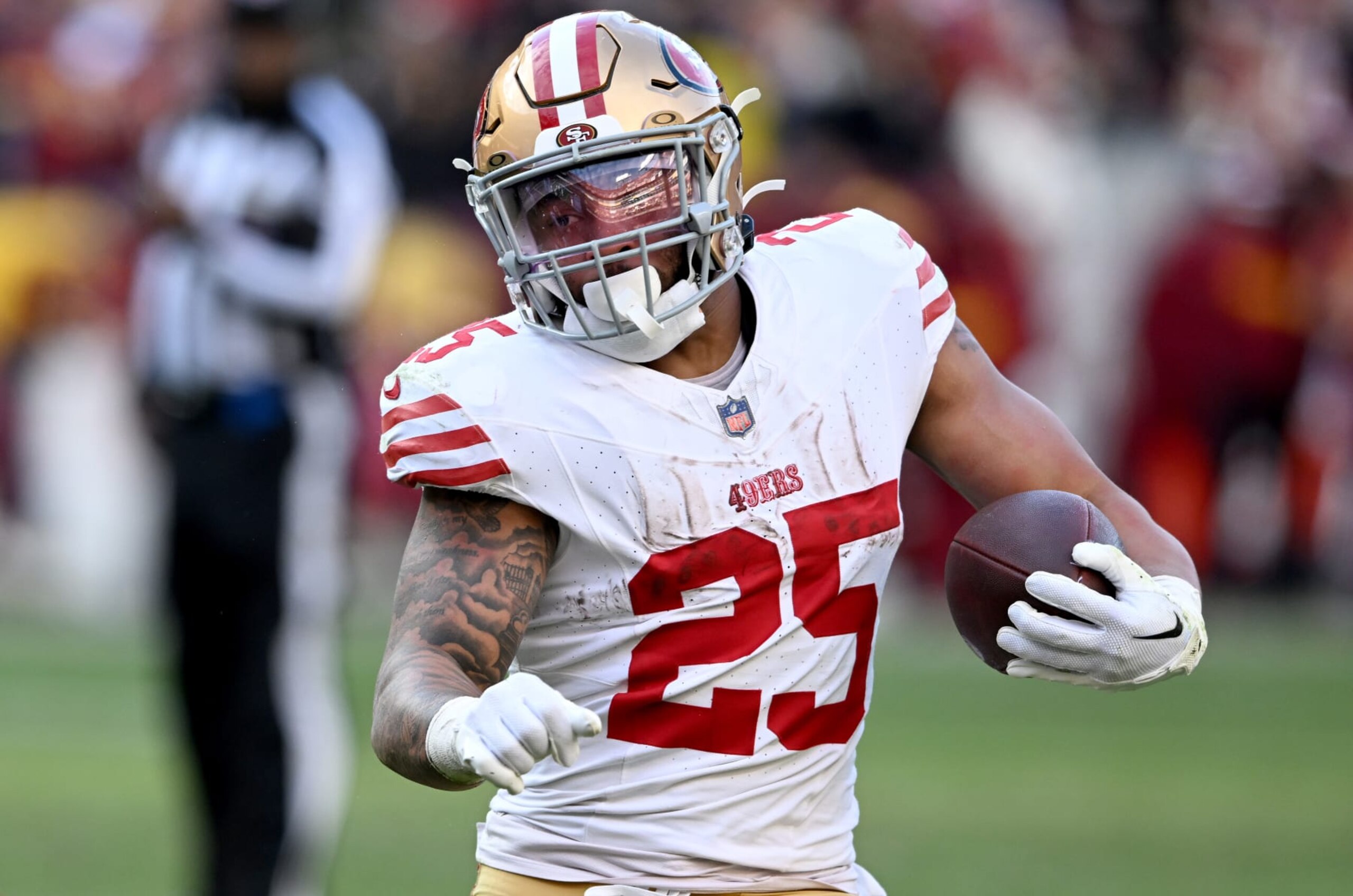 LANDOVER, MARYLAND - DECEMBER 31: Elijah Mitchell #25 of the San Francisco 49ers rushes the ball against the Washington Commanders at FedExField on December 31, 2023 in Landover, Maryland. (Photo by G Fiume/Getty Images)