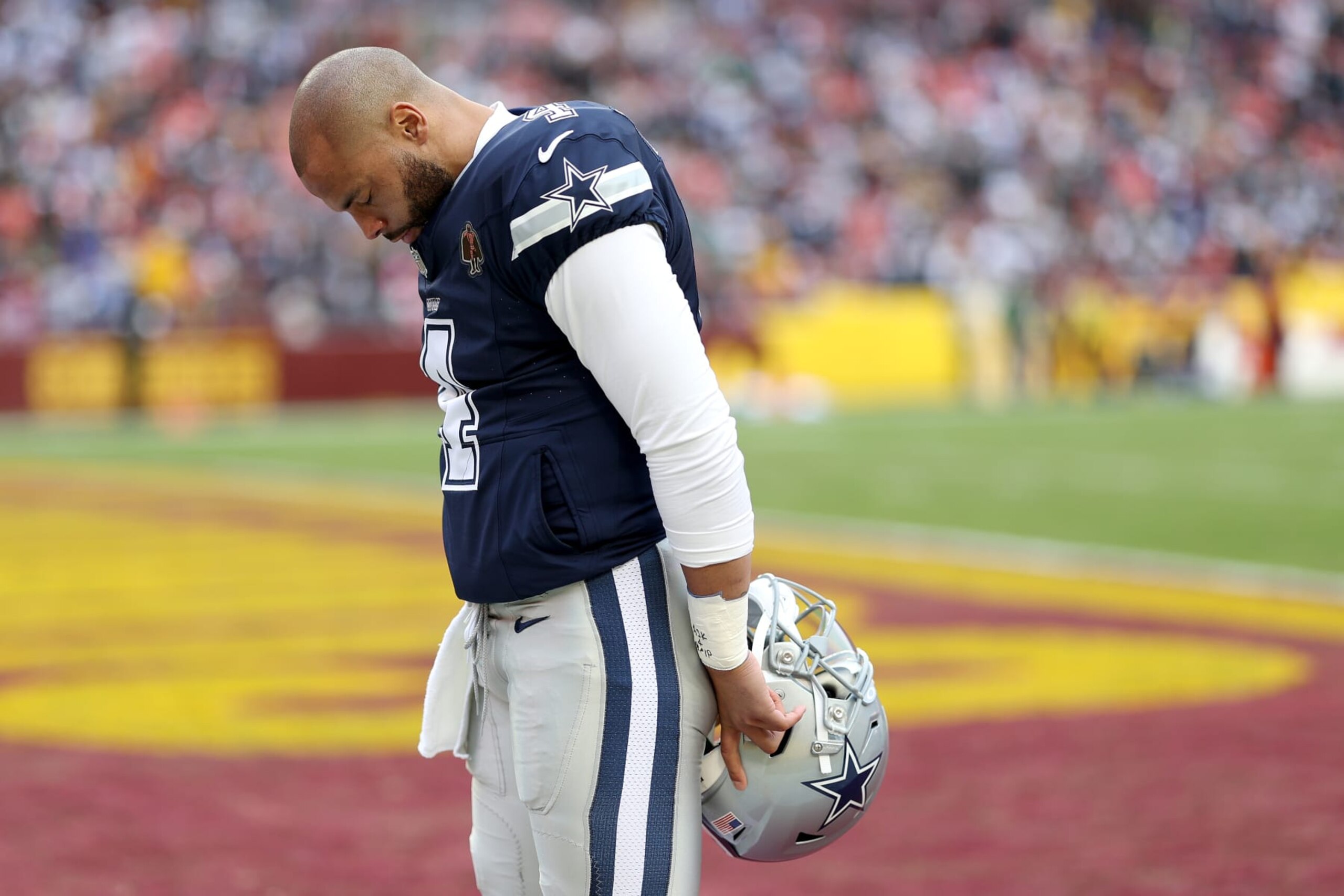 LANDOVER, MARYLAND - JANUARY 07: Dak Prescott #4 of the Dallas Cowboys waits in the end zone before the game against the Washington Commanders at FedExField on January 07, 2024 in Landover, Maryland. (Photo by Patrick Smith/Getty Images)