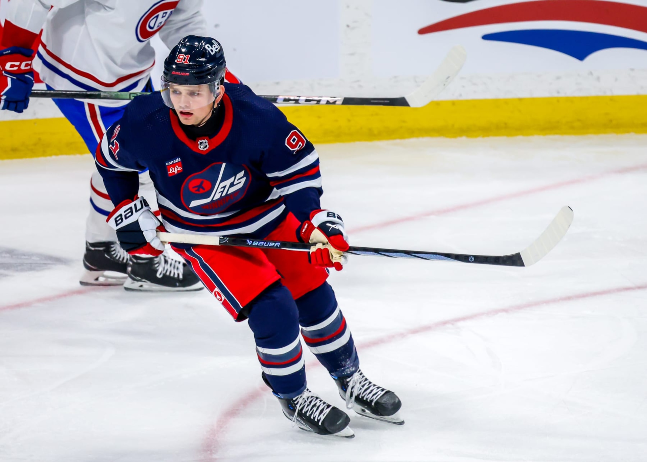WINNIPEG, CANADA - DECEMBER 18: Cole Perfetti #91 of the Winnipeg Jets skates during first period action against the Montreal Canadiens at Canada Life Centre on December 18, 2023 in Winnipeg, Manitoba, Canada. (Photo by Jonathan Kozub/NHLI via Getty Images)