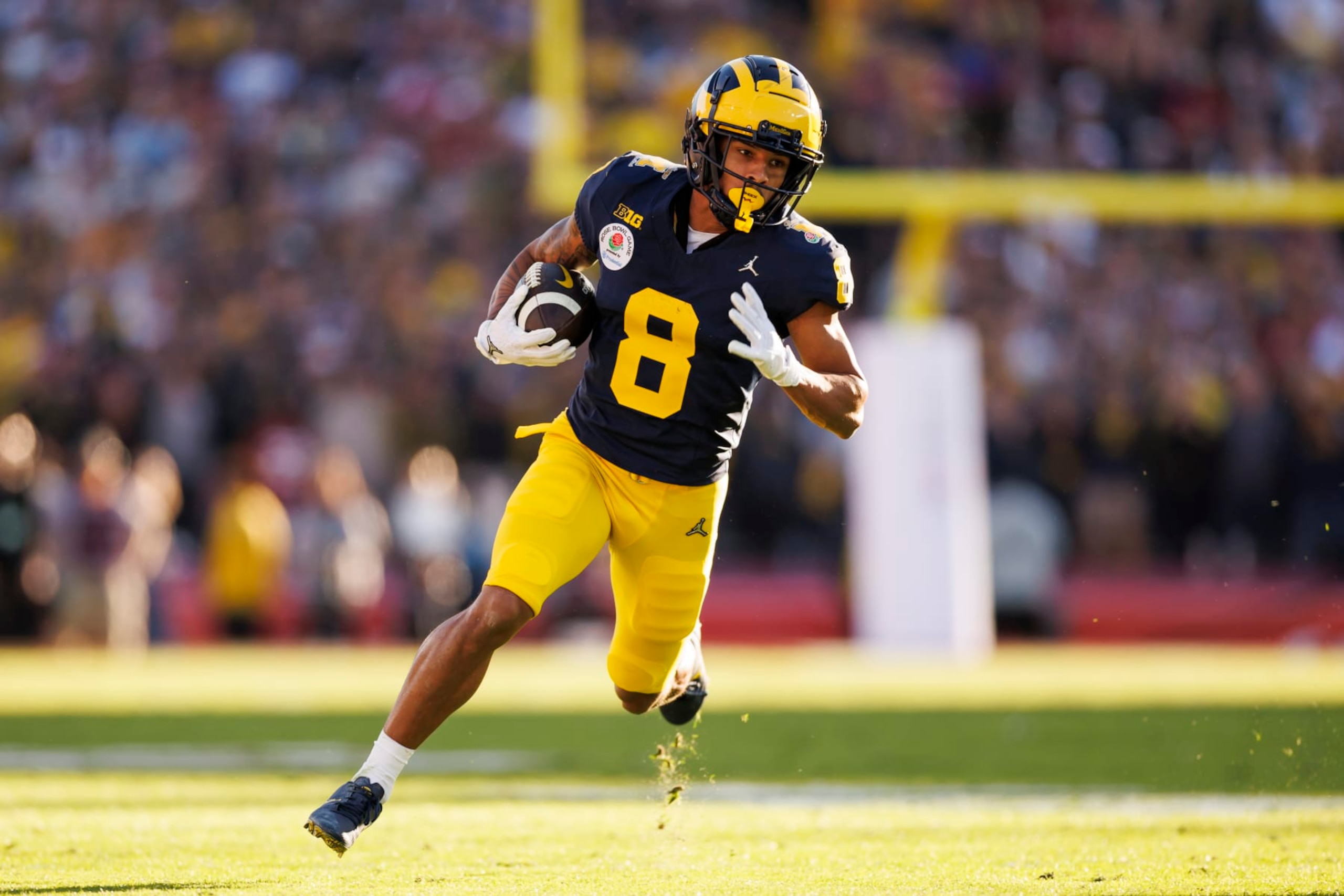 PASADENA, CALIFORNIA - JANUARY 01: Wide receiver Tyler Morris #8 of the Michigan Wolverines runs the ball on his way to score a touchdown during the CFP Semifinal Rose Bowl Game against the Alabama Crimson Tide at Rose Bowl Stadium on January 1, 2024 in Pasadena, California. (Photo by Ryan Kang/Getty Images)