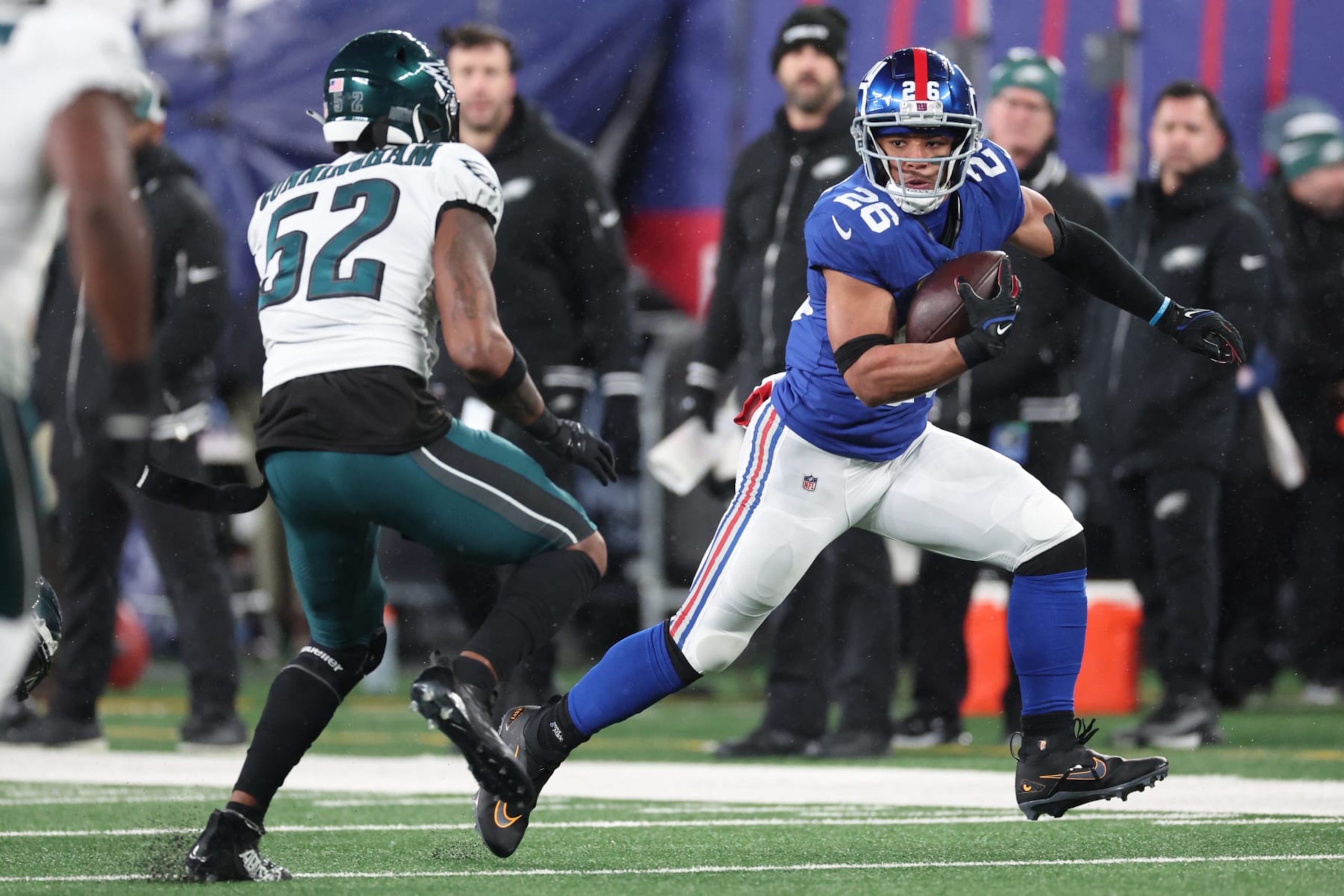EAST RUTHERFORD, NEW JERSEY - JANUARY 07: Saquon Barkley #26 of the New York Giants runs the ball while defended by Zach Cunningham #52 of the Philadelphia Eagles during the first half at MetLife Stadium on January 07, 2024 in East Rutherford, New Jersey. (Photo by Al Bello/Getty Images)