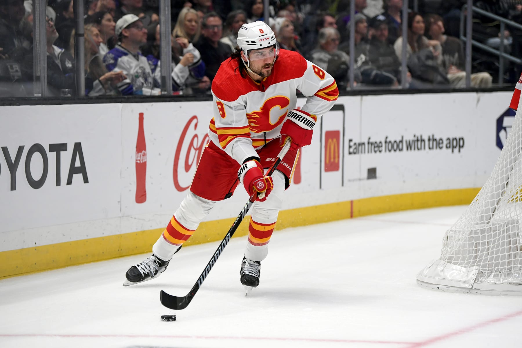 LOS ANGELES, CA - DECEMBER 23: Calgary Flames Defenceman Chris Tanev (8) carries the puck behind the Calgary net during a game between the Calgary Flames and the Los Angeles Kings on December 23, 2023 at the Crypto.com Arena in Los Angeles, CA.  (Photo by Rob Curtis/Icon Sportswire via Getty Images)