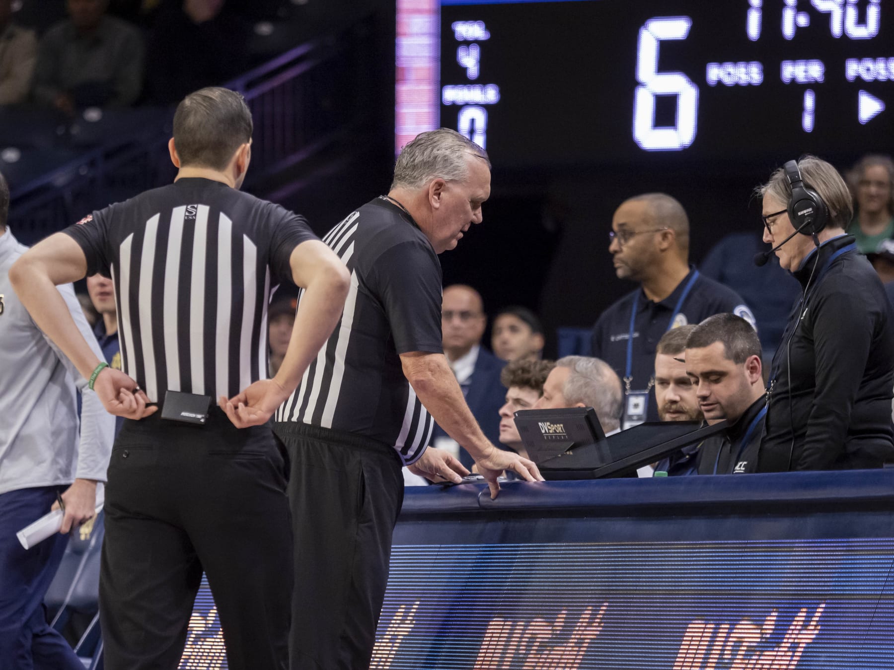 SOUTH BEND, IN - DECEMBER 30: ACC conference official review a play on the DVSPORT replay monitor during a college basketball game between the Virginia Cavaliers and the Notre Dame Fighting Irish on December 30, 2023 at Purcell Pavilion in South Bend, Indiana. (Photo by Joseph Weiser/Icon Sportswire via Getty Images)