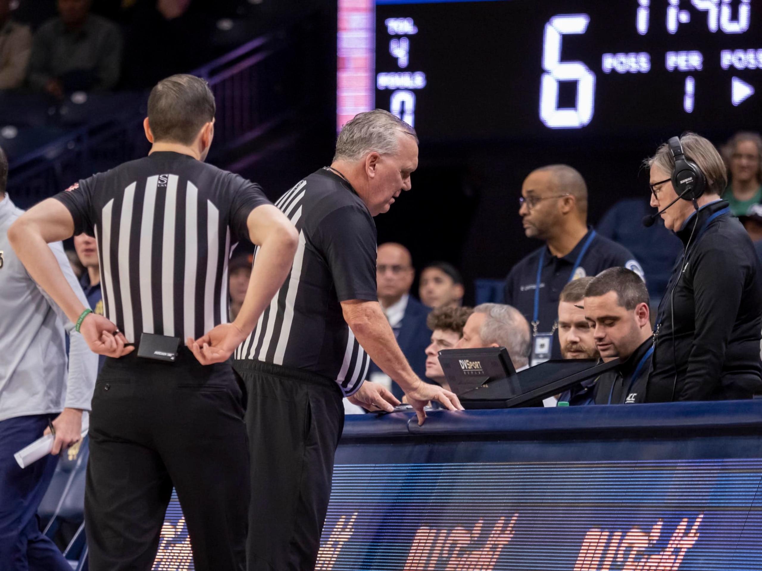 SOUTH BEND, IN - DECEMBER 30: ACC conference official review a play on the DVSPORT replay monitor during a college basketball game between the Virginia Cavaliers and the Notre Dame Fighting Irish on December 30, 2023 at Purcell Pavilion in South Bend, Indiana. (Photo by Joseph Weiser/Icon Sportswire via Getty Images)