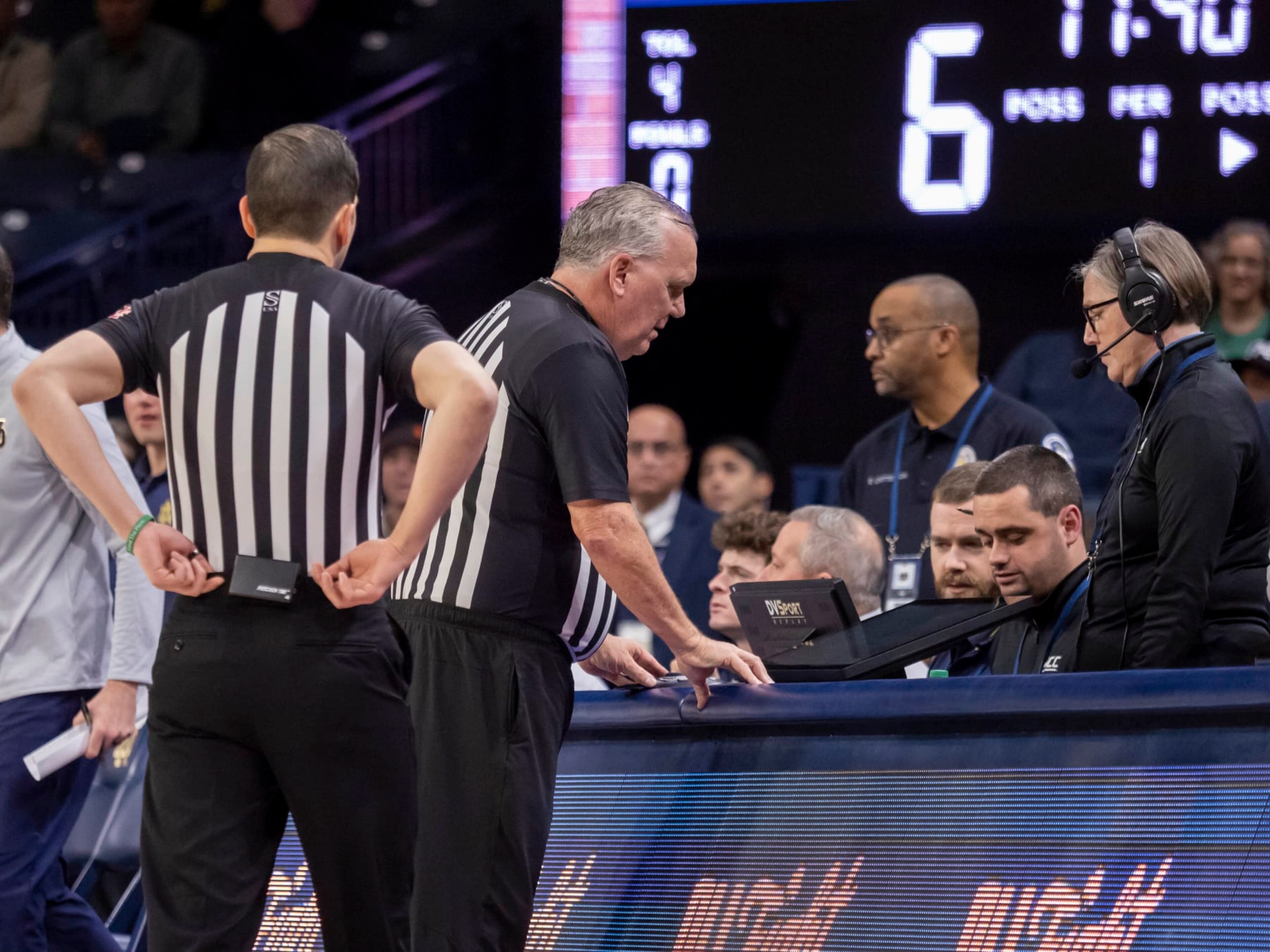 SOUTH BEND, IN - DECEMBER 30: ACC conference official review a play on the DVSPORT replay monitor during a college basketball game between the Virginia Cavaliers and the Notre Dame Fighting Irish on December 30, 2023 at Purcell Pavilion in South Bend, Indiana. (Photo by Joseph Weiser/Icon Sportswire via Getty Images)
