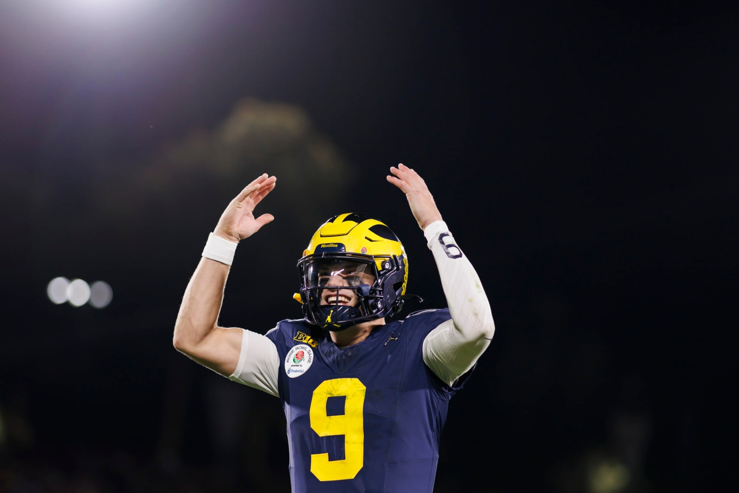 PASADENA, CALIFORNIA - JANUARY 01: Quarterback J.J. McCarthy #9 of the Michigan Wolverines celebrates on the sideline in overtime during the CFP Semifinal Rose Bowl Game against the Alabama Crimson Tide at Rose Bowl Stadium on January 1, 2024 in Pasadena, California. (Photo by Ryan Kang/Getty Images)