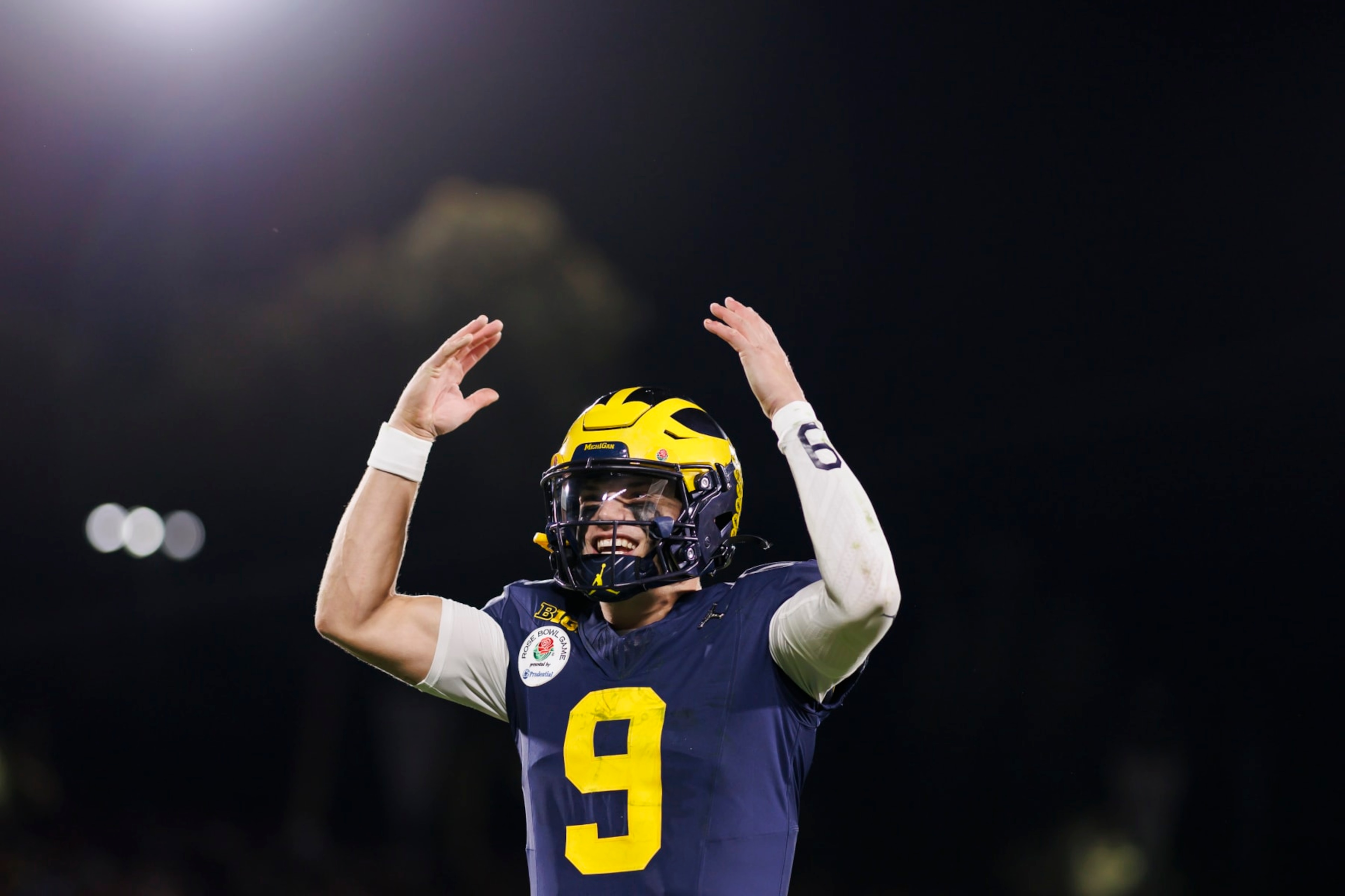 PASADENA, CALIFORNIA - JANUARY 01: Quarterback J.J. McCarthy #9 of the Michigan Wolverines celebrates on the sideline in overtime during the CFP Semifinal Rose Bowl Game against the Alabama Crimson Tide at Rose Bowl Stadium on January 1, 2024 in Pasadena, California. (Photo by Ryan Kang/Getty Images)