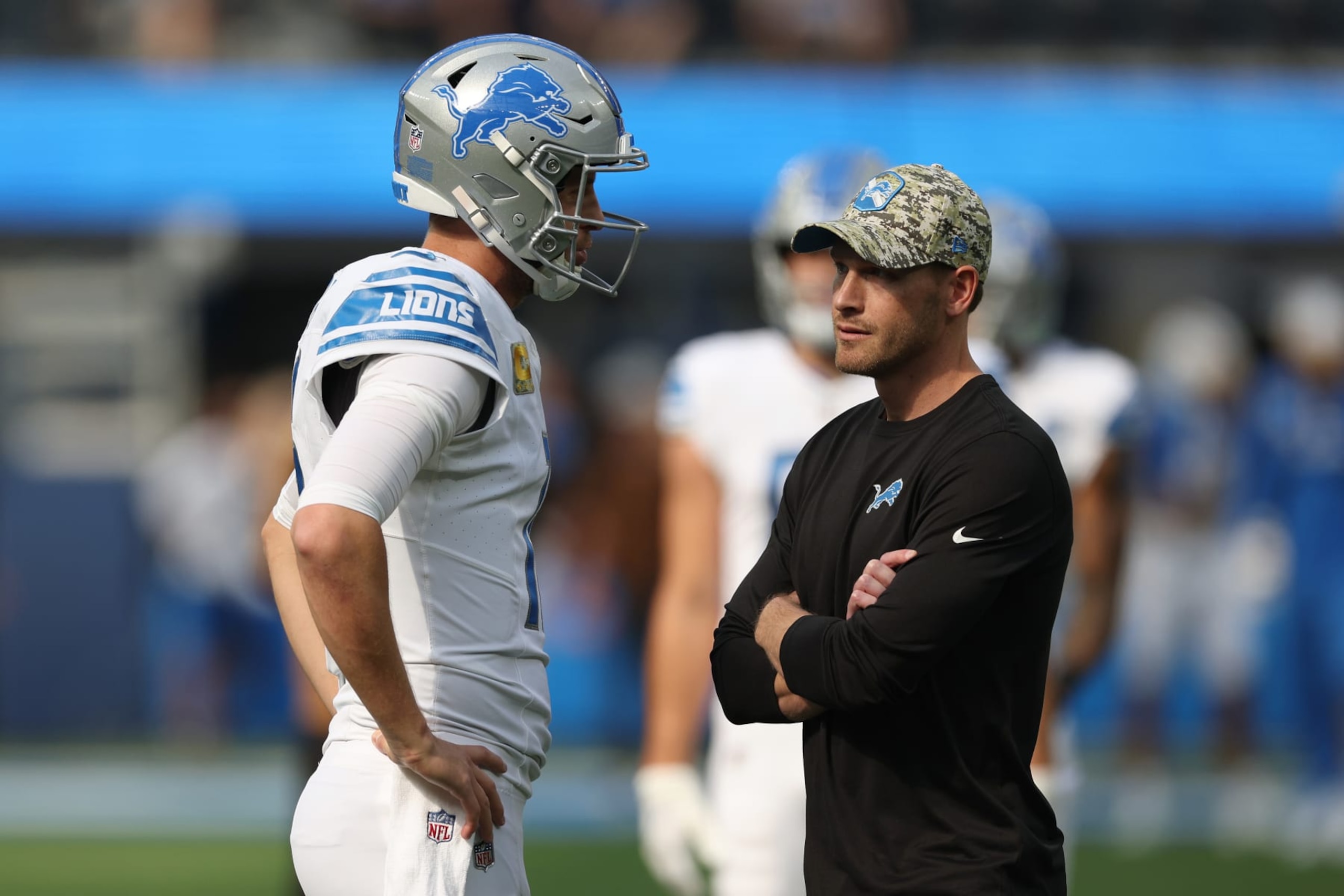 INGLEWOOD, CALIFORNIA - NOVEMBER 12: Jared Goff #16 of the Detroit Lions talks with offensive coordinator Ben Johnson before the game against the Los Angeles Chargers at SoFi Stadium on November 12, 2023 in Inglewood, California. (Photo by Harry How/Getty Images)