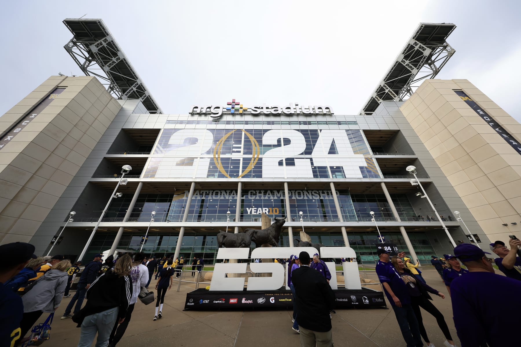 HOUSTON, TEXAS - JANUARY 08: Fans stand outside NRG Stadium prior to the 2024 CFP National Championship game between the Washington Huskies and Michigan Wolverines on January 08, 2024 in Houston, Texas. (Photo by Carmen Mandato/Getty Images)