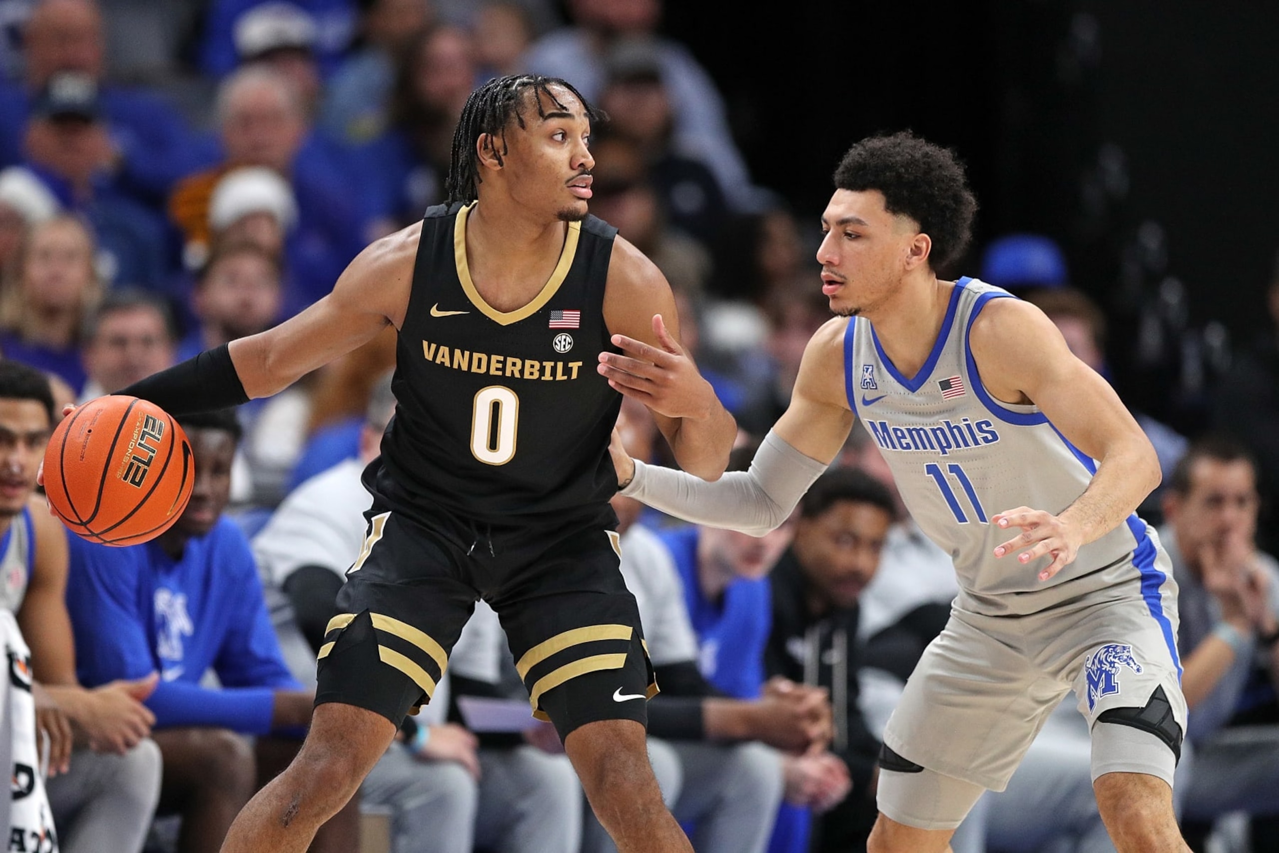 MEMPHIS, TENNESSEE - DECEMBER 23: Tyrin Lawrence #0 of the Vanderbilt Commodores handles the ball against Jahvon Quinerly #11 of the Memphis Tigers during the first half at FedExForum on December 23, 2023 in Memphis, Tennessee. (Photo by Justin Ford/Getty Images)