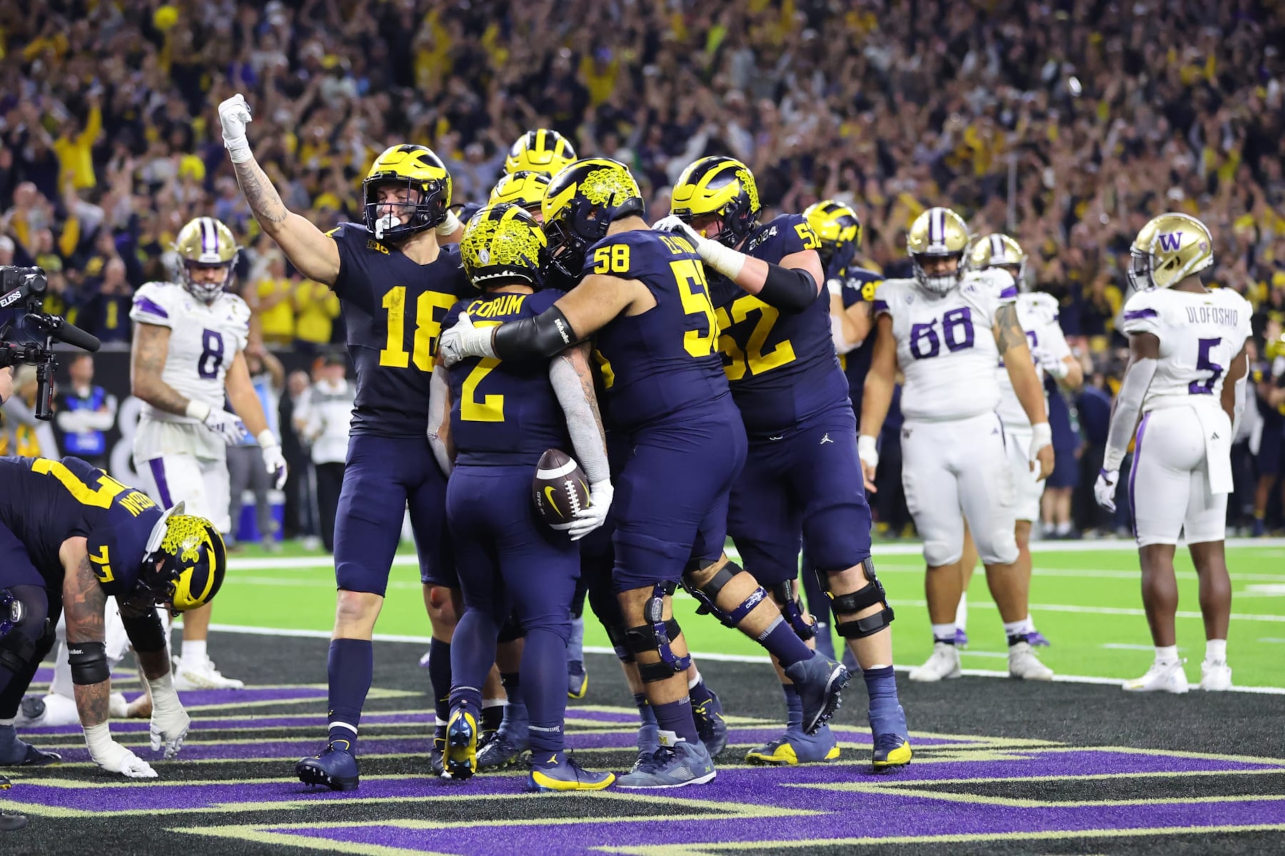 HOUSTON, TEXAS - JANUARY 08: Blake Corum #2 of the Michigan Wolverines celebrates with teammates after scoring a touchdown in the fourth quarter against the Washington Huskies during the 2024 CFP National Championship game at NRG Stadium on January 08, 2024 in Houston, Texas. (Photo by Stacy Revere/Getty Images)
