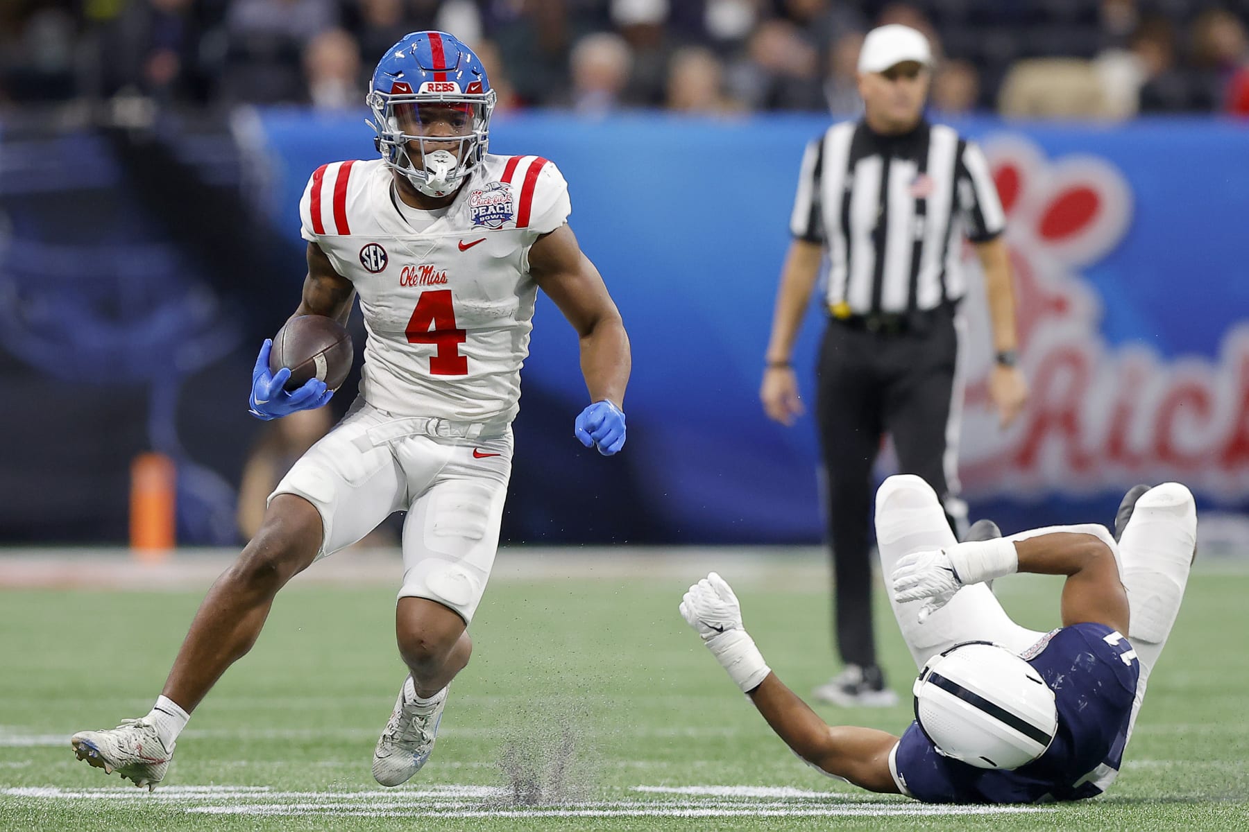 ATLANTA, GEORGIA - DECEMBER 30: Quinshon Judkins #4 of the Mississippi Rebels carries the ball against the Penn State Nittany Lions during the third quarter in the Chick-fil-A Peach Bowl at Mercedes-Benz Stadium on December 30, 2023 in Atlanta, Georgia. (Photo by Todd Kirkland/Getty Images)