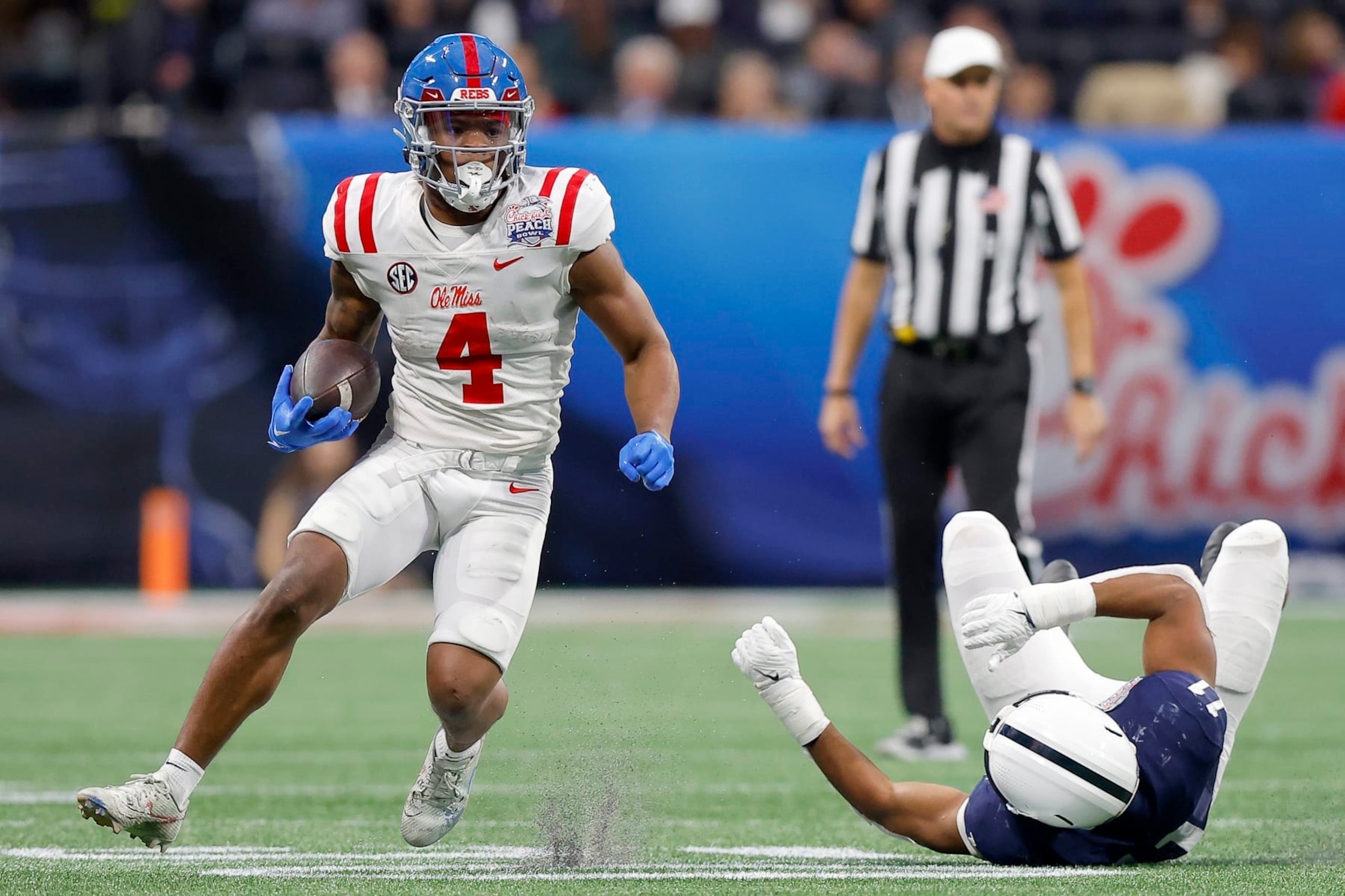 ATLANTA, GEORGIA - DECEMBER 30: Quinshon Judkins #4 of the Mississippi Rebels carries the ball against the Penn State Nittany Lions during the third quarter in the Chick-fil-A Peach Bowl at Mercedes-Benz Stadium on December 30, 2023 in Atlanta, Georgia. (Photo by Todd Kirkland/Getty Images)