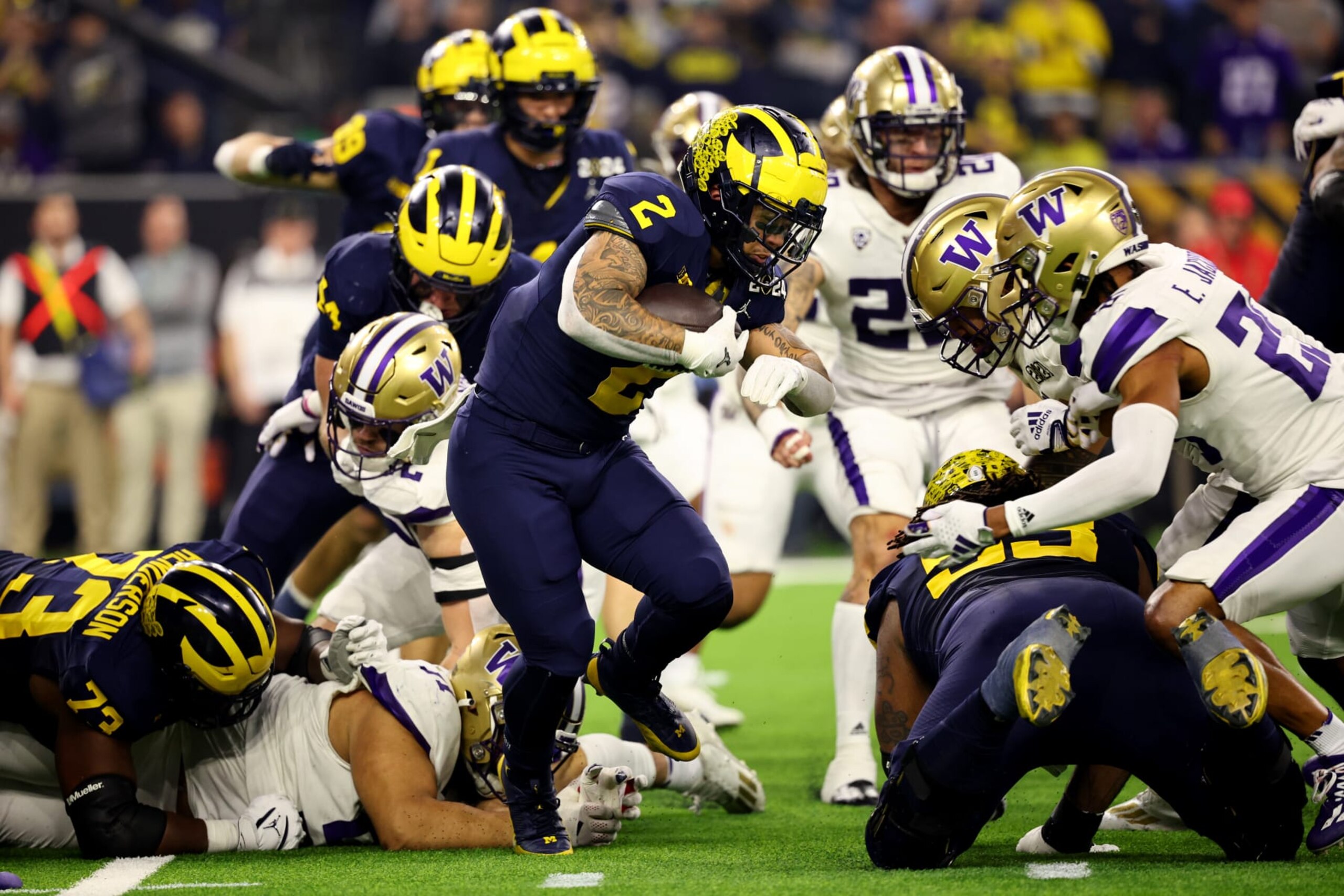HOUSTON, TEXAS - JANUARY 8: Blake Corum #2 of the Michigan Wolverines rushes against the Washington Huskies during the 2024 CFP National Championship game at NRG Stadium on January 8, 2024 in Houston, Texas. (Photo by Jamie Schwaberow/Getty Images)