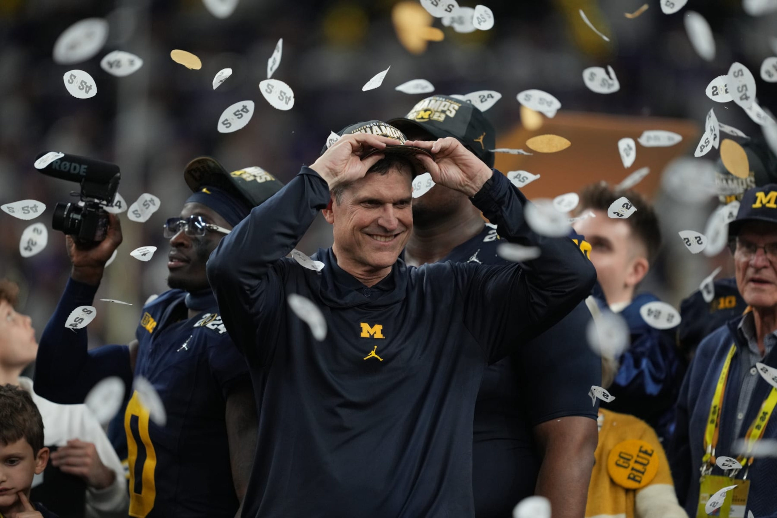 HOUSTON, TX - JANUARY 08: Head Coach Jim Harbaugh of the Michigan Wolverines celebrates after the Michigan Wolverines defeat the Washington Huskies 34-13 in the CFP National Championship game on January 8, 2024, at NRG Stadium in Houston, TX. (Photo by Daniel Dunn/Icon Sportswire via Getty Images)