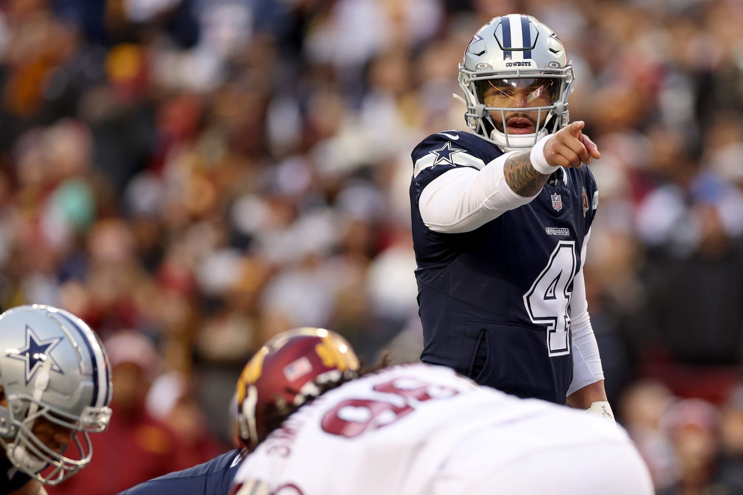 LANDOVER, MARYLAND - JANUARY 07: Dak Prescott #4 of the Dallas Cowboys calls a play during the first half against the Washington Commanders at FedExField on January 07, 2024 in Landover, Maryland. (Photo by Patrick Smith/Getty Images)