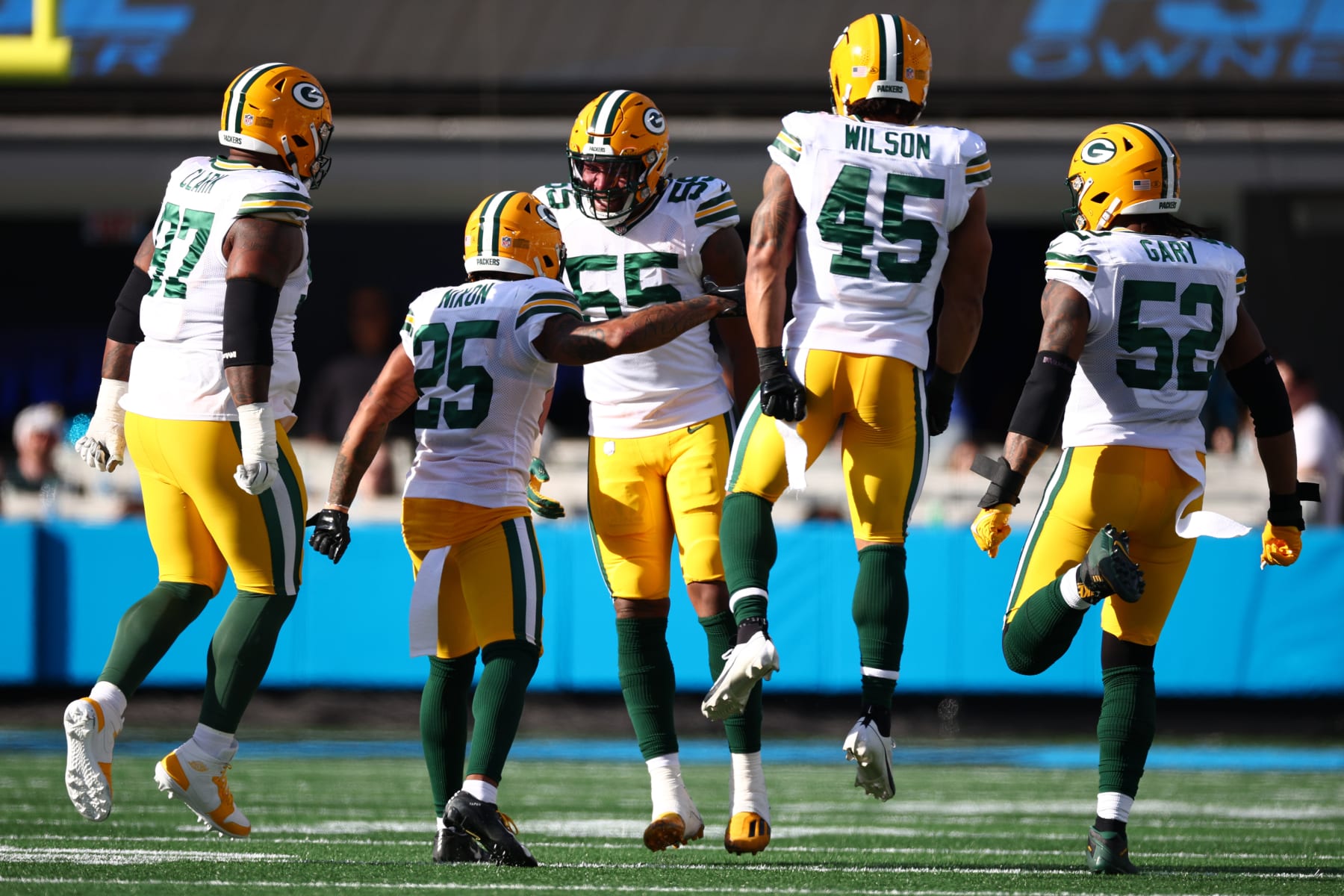 CHARLOTTE, NORTH CAROLINA - DECEMBER 24: Kingsley Enagbare #55 of the Green Bay Packers celebrates a play with teammates during the second quarter against the Carolina Panthers at Bank of America Stadium on December 24, 2023 in Charlotte, North Carolina. (Photo by Jared C. Tilton/Getty Images)
