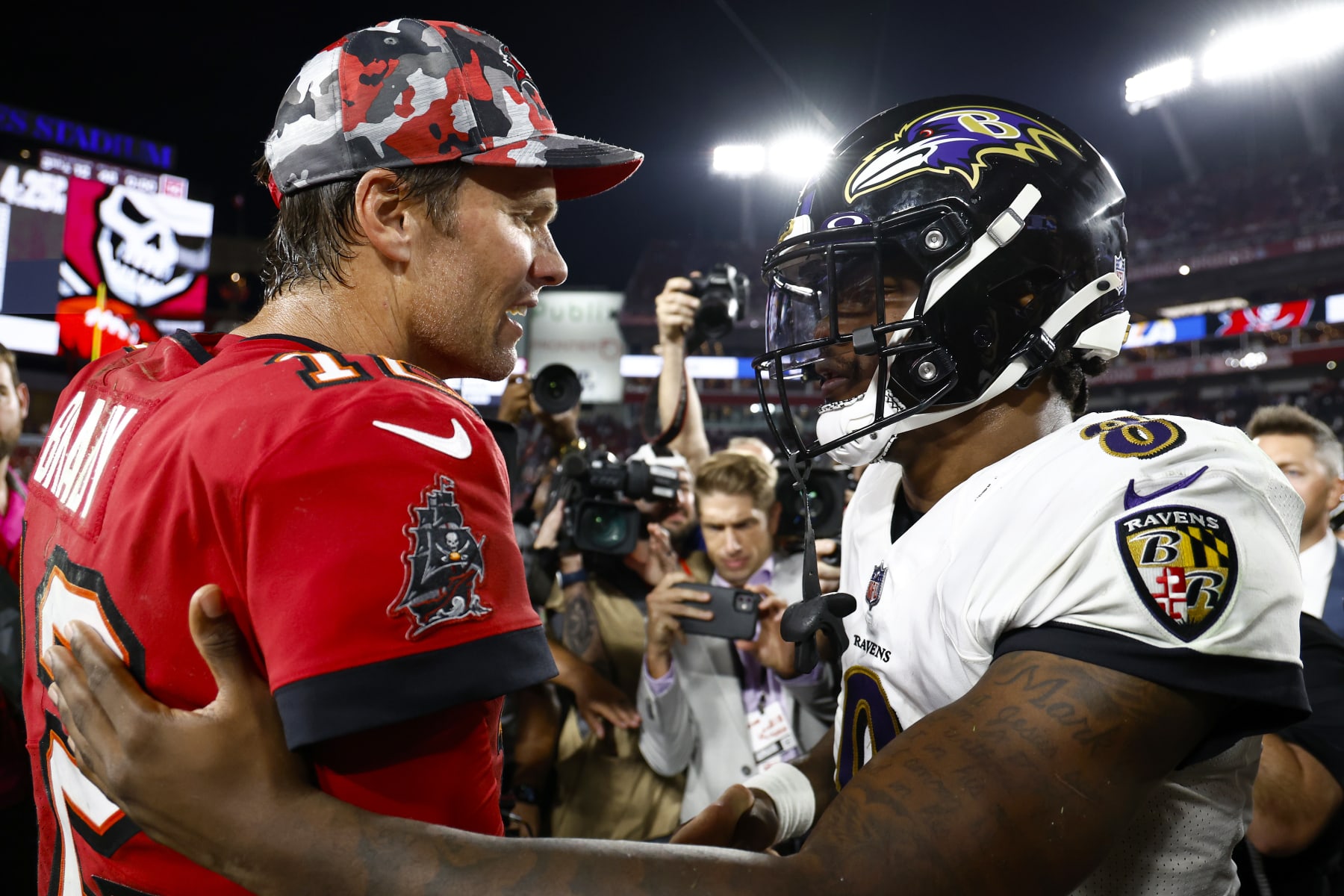 TAMPA, FLORIDA - OCTOBER 27: Tom Brady #12 of the Tampa Bay Buccaneers and Lamar Jackson #8 of the Baltimore Ravens meet on the field after their game at Raymond James Stadium on October 27, 2022 in Tampa, Florida. (Photo by Douglas P. DeFelice/Getty Images)