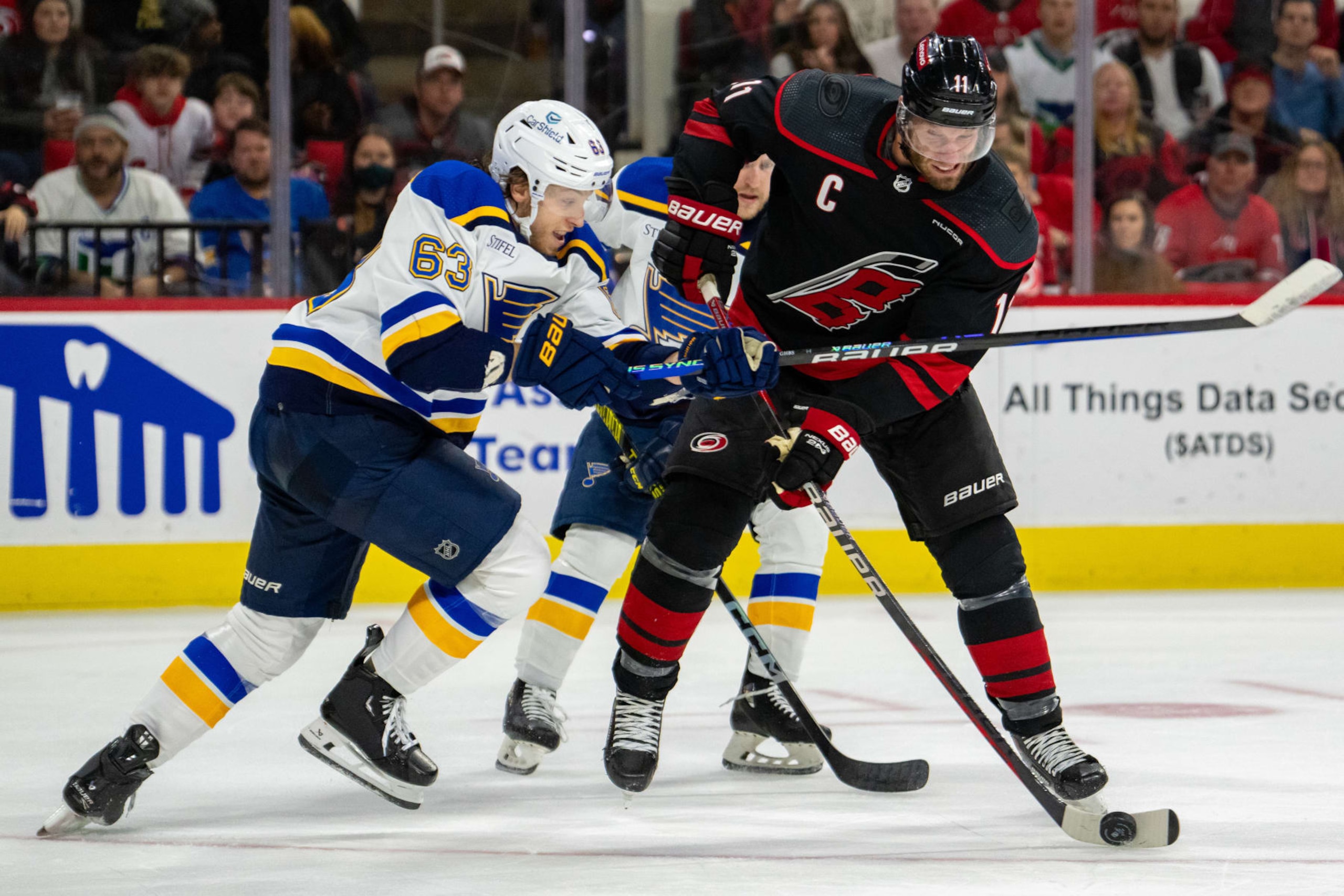 RALEIGH, NORTH CAROLINA - JANUARY 06: Jordan Staal #11 of the Carolina Hurricanes shoots the puck while defended by Jake Neighbours #63 of the St. Louis Blues in the second period during their game at PNC Arena on January 06, 2024 in Raleigh, North Carolina. (Photo by Jacob Kupferman/Getty Images) RALEIGH, NORTH CAROLINA - JANUARY 06: Jordan Staal #11 of the Carolina Hurricanes shoots the puck while defended by Jake Neighbours #63 of the St. Louis Blues in the second period during their game at PNC Arena on January 06, 2024 in Raleigh, North Carolina. (Photo by Jacob Kupferman/Getty Images)