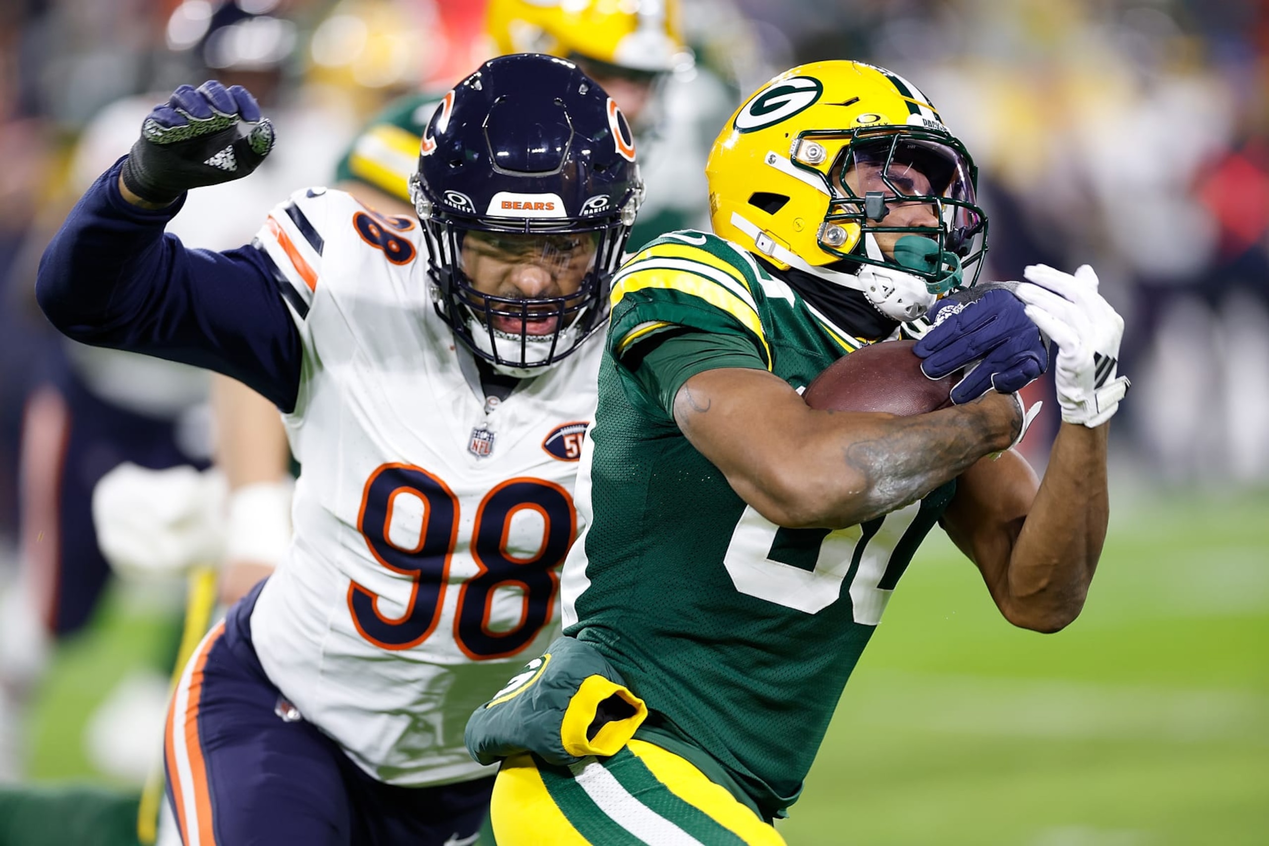 GREEN BAY, WISCONSIN - JANUARY 07: Bo Melton #80 of the Green Bay Packers carries the ball after a catch against the Chicago Bears at Lambeau Field on January 07, 2024 in Green Bay, Wisconsin. (Photo by John Fisher/Getty Images)