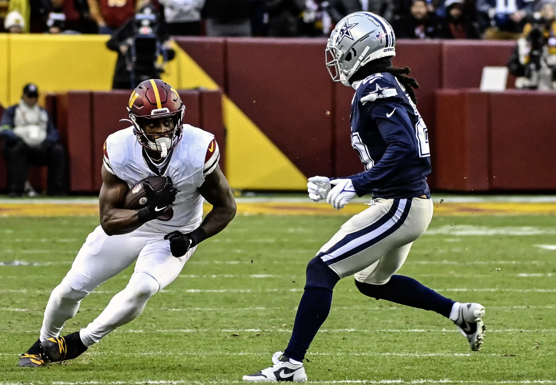 LANDOVER, MD - JANUARY 07: Washington Commanders running back Brian Robinson Jr. (8) in action against Dallas Cowboys cornerback Stephon Gilmore (21) during the NFL game between the Dallas Cowboys and the Washington Commanders on January 7, 2024 at FedEx Field in Landover, MD. (Photo by Mark Goldman/Icon Sportswire via Getty Images)
