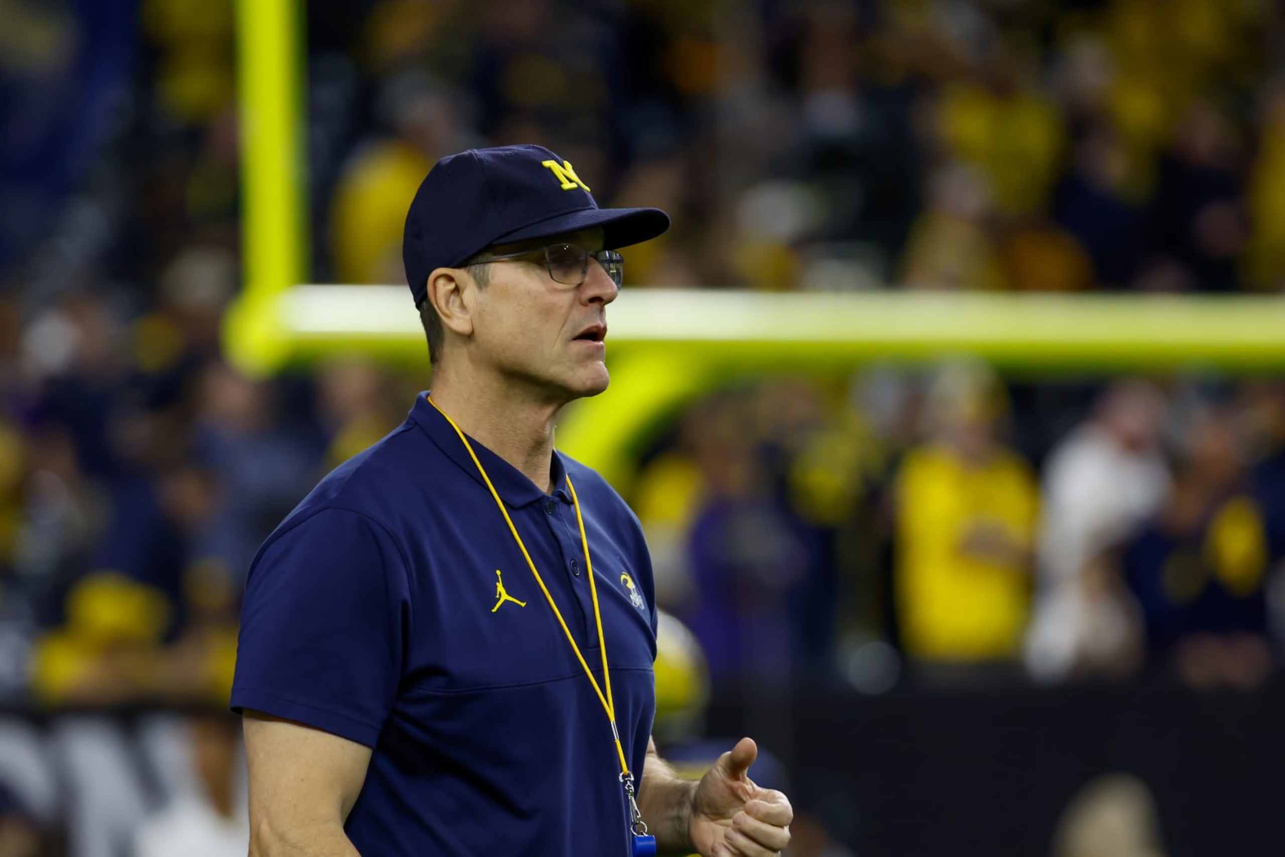 HOUSTON, TX - JANUARY 08: Michigan Wolverines head coach Jim Harbaugh enters the field for warmups before the CFP National Championship game Michigan Wolverines and Washington Huskies on January 8, 2024, at NRG Stadium in Houston, Texas. (Photo by David Buono/Icon Sportswire via Getty Images)
