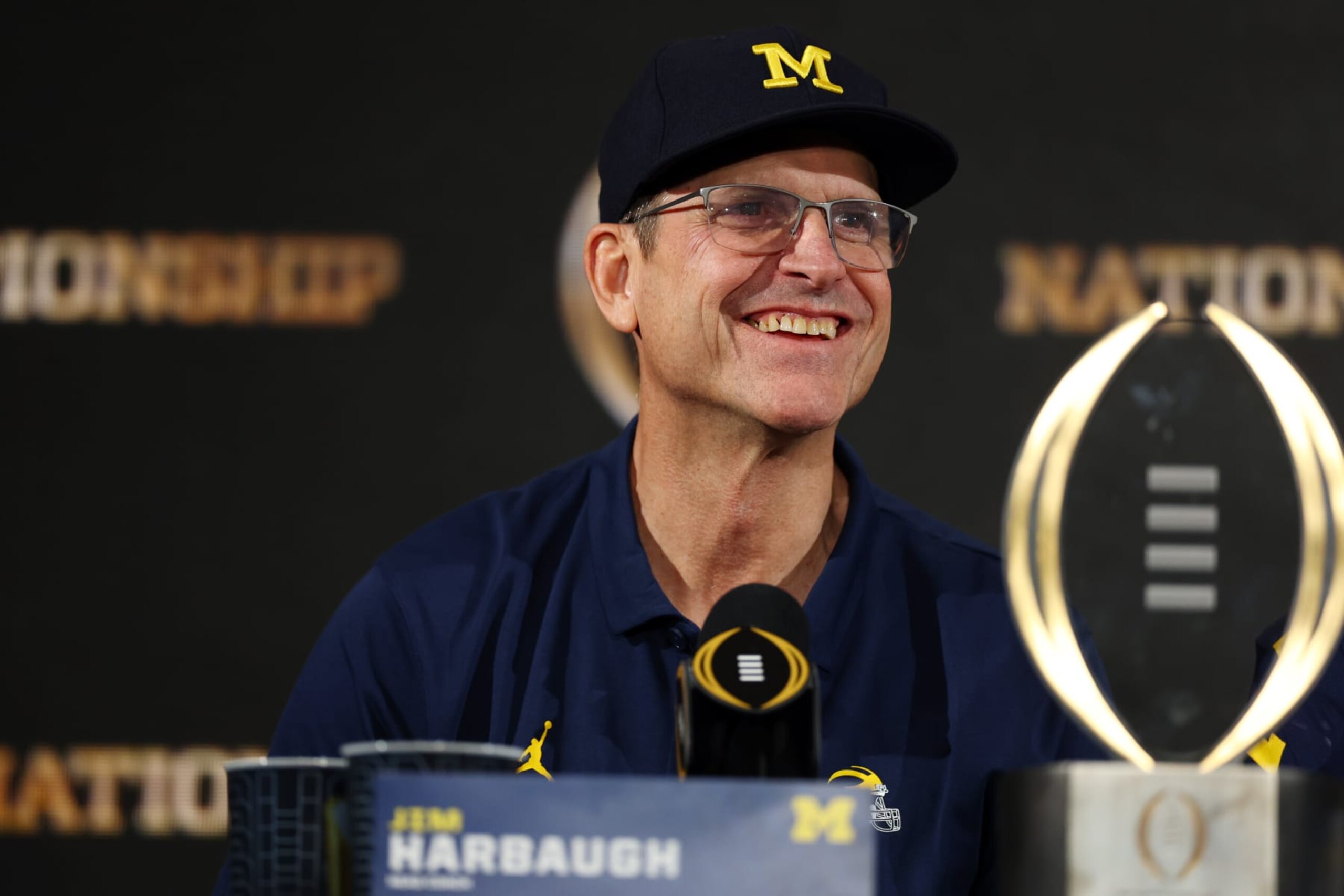 HOUSTON, TEXAS - JANUARY 08: Head coach Jim Harbaugh of the Michigan Wolverines reacts during the press conference after defeating the Washington Huskies during the 2024 CFP National Championship game at NRG Stadium on January 08, 2024 in Houston, Texas. Michigan defeated Washington 34-13. (Photo by Maddie Meyer/Getty Images) HOUSTON, TEXAS - JANUARY 08: Head coach Jim Harbaugh of the Michigan Wolverines reacts during the press conference after defeating the Washington Huskies during the 2024 CFP National Championship game at NRG Stadium on January 08, 2024 in Houston, Texas. Michigan defeated Washington 34-13. (Photo by Maddie Meyer/Getty Images)