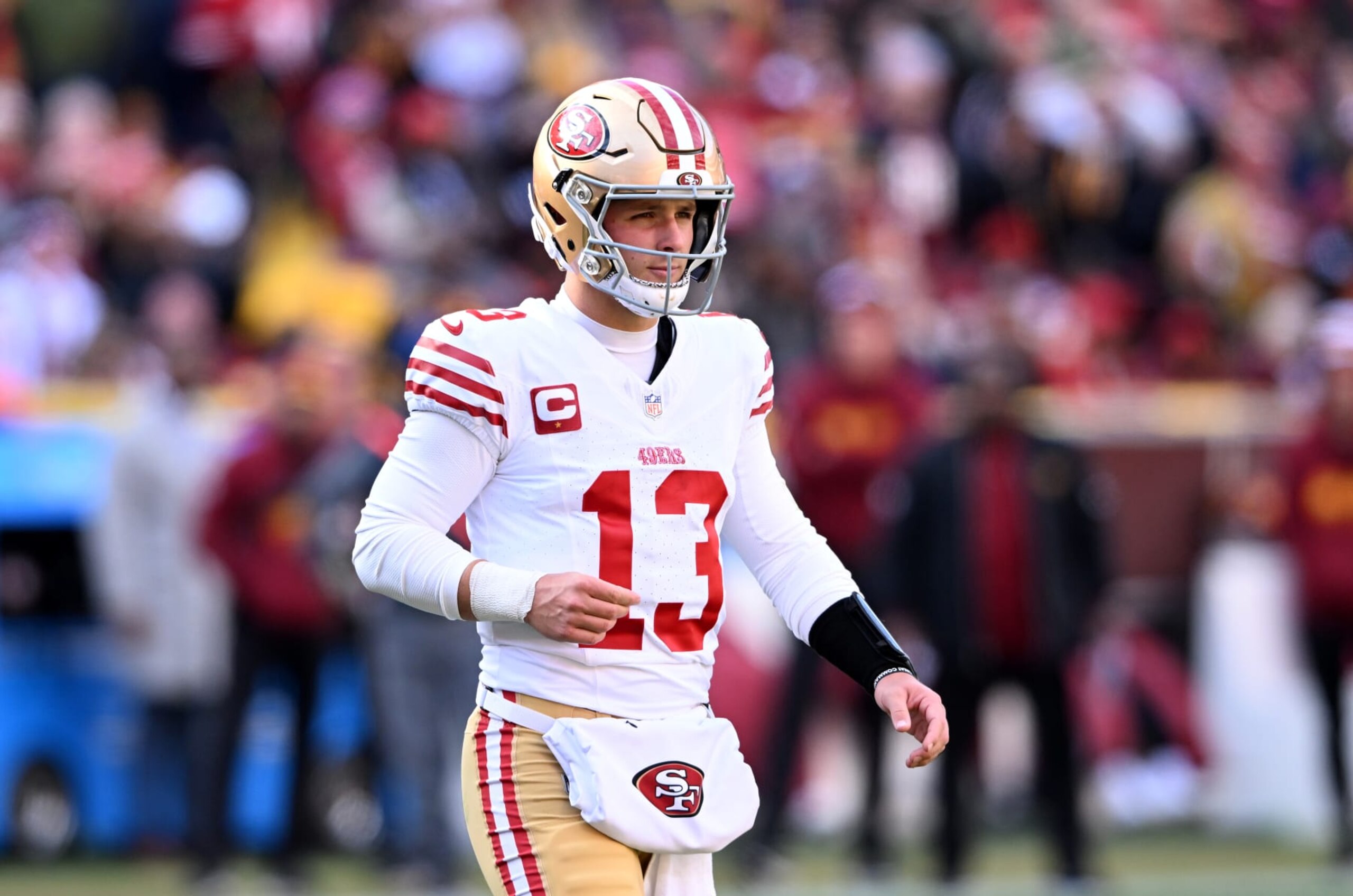 LANDOVER, MARYLAND - DECEMBER 31: Brock Purdy #13 of the San Francisco 49ers walks across the field during the game against the Washington Commanders at FedExField on December 31, 2023 in Landover, Maryland. (Photo by G Fiume/Getty Images)